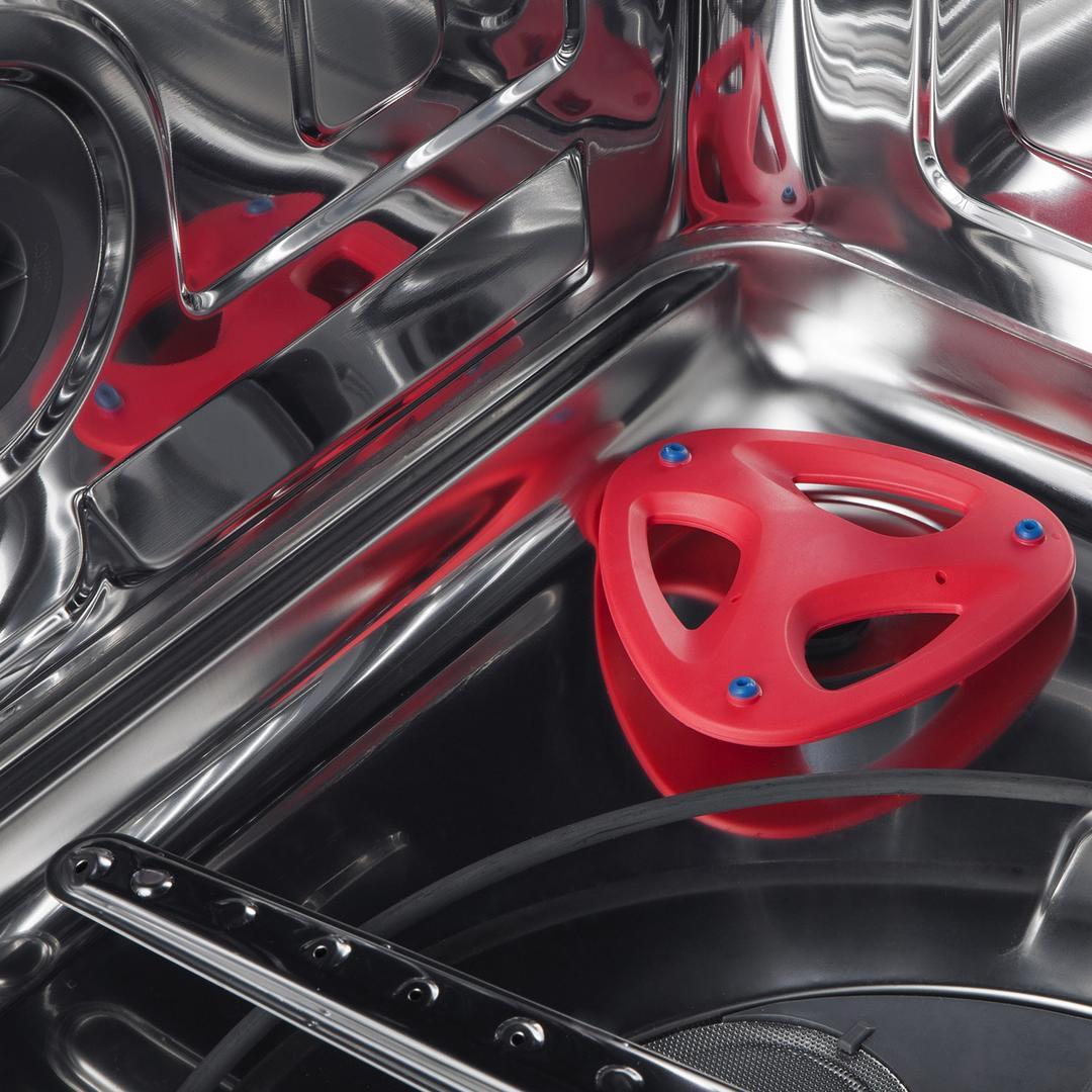 Range oven interior with red burner cap and stainless steel oven rack