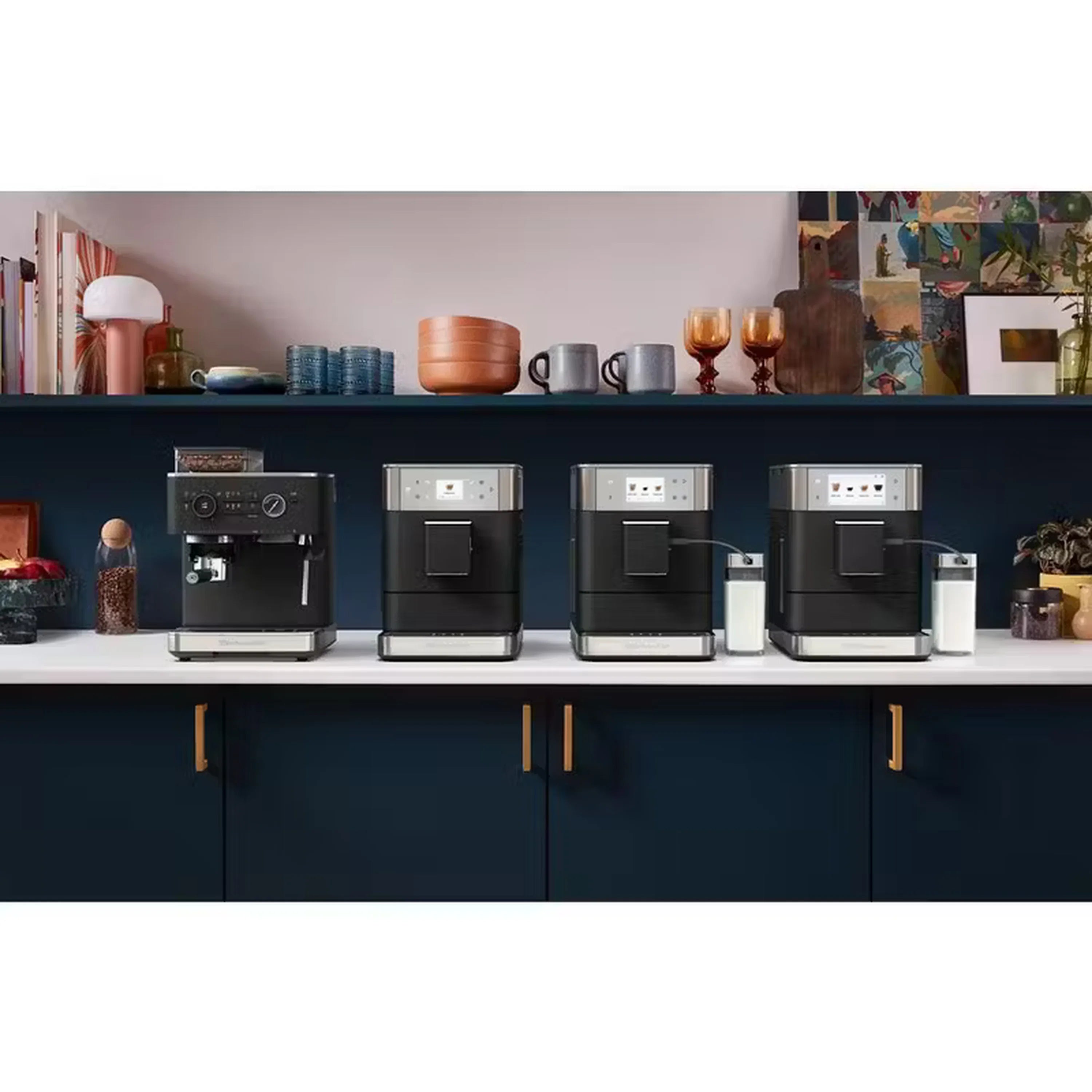 Multiple black and stainless fully automatic espresso machines lined up on a kitchen shelf.