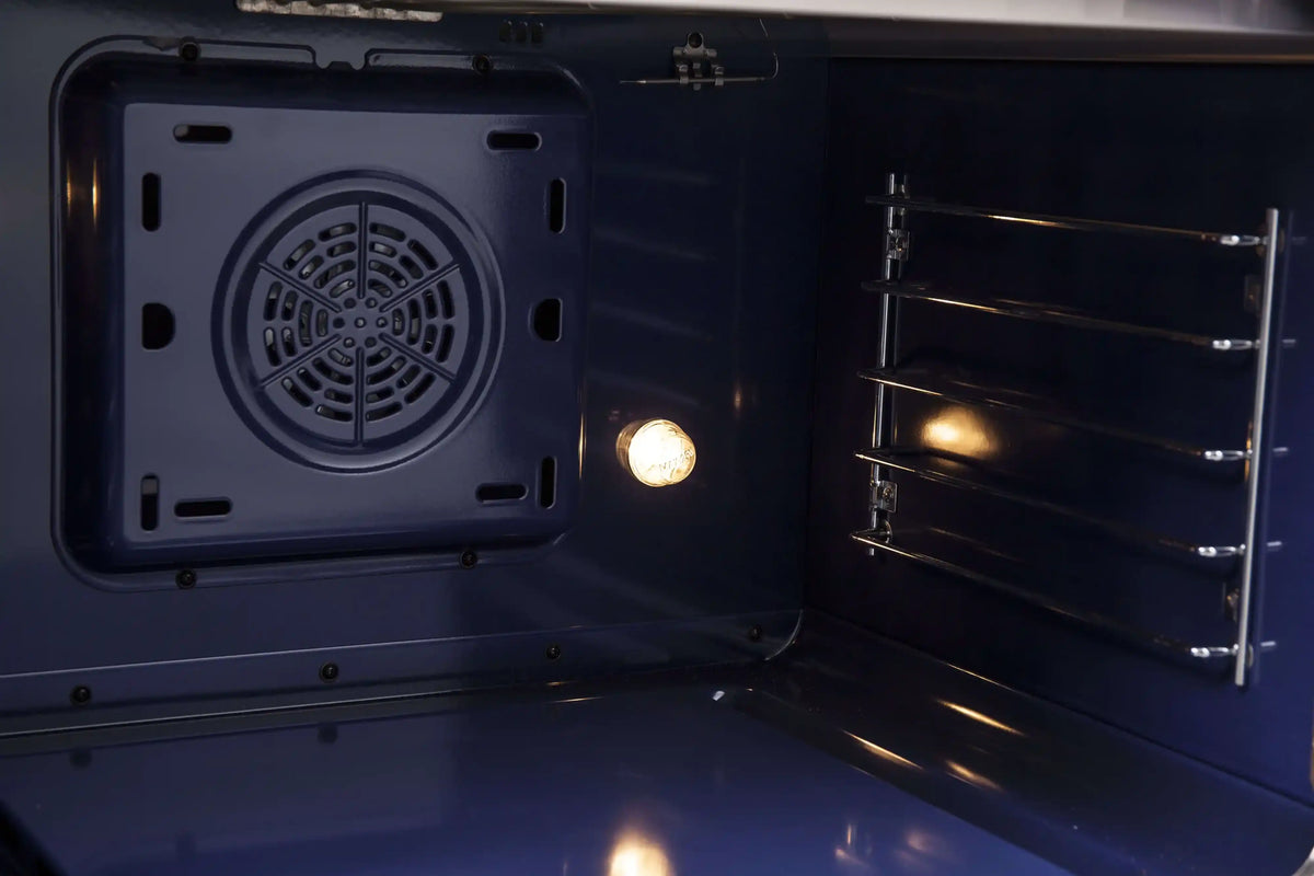 Dual fuel range oven door open, visible fan and interior racks