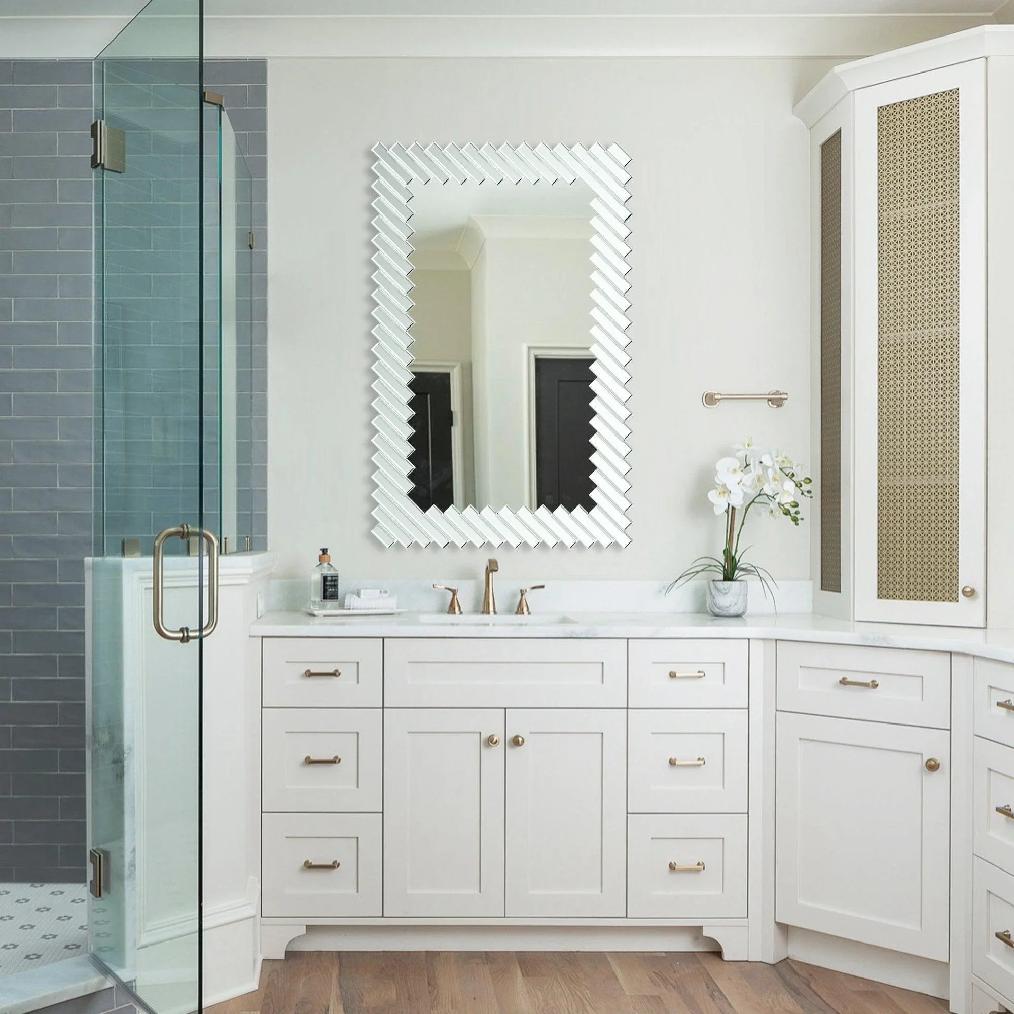 Wall-mounted rectangular mirror with silver scalloped slat frame above white vanity
