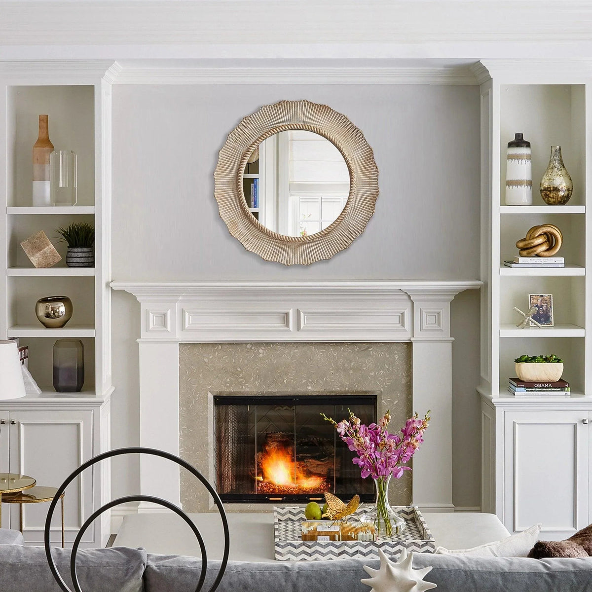 Round wall mirror with textured gold-brown frame, mounted on a wall.