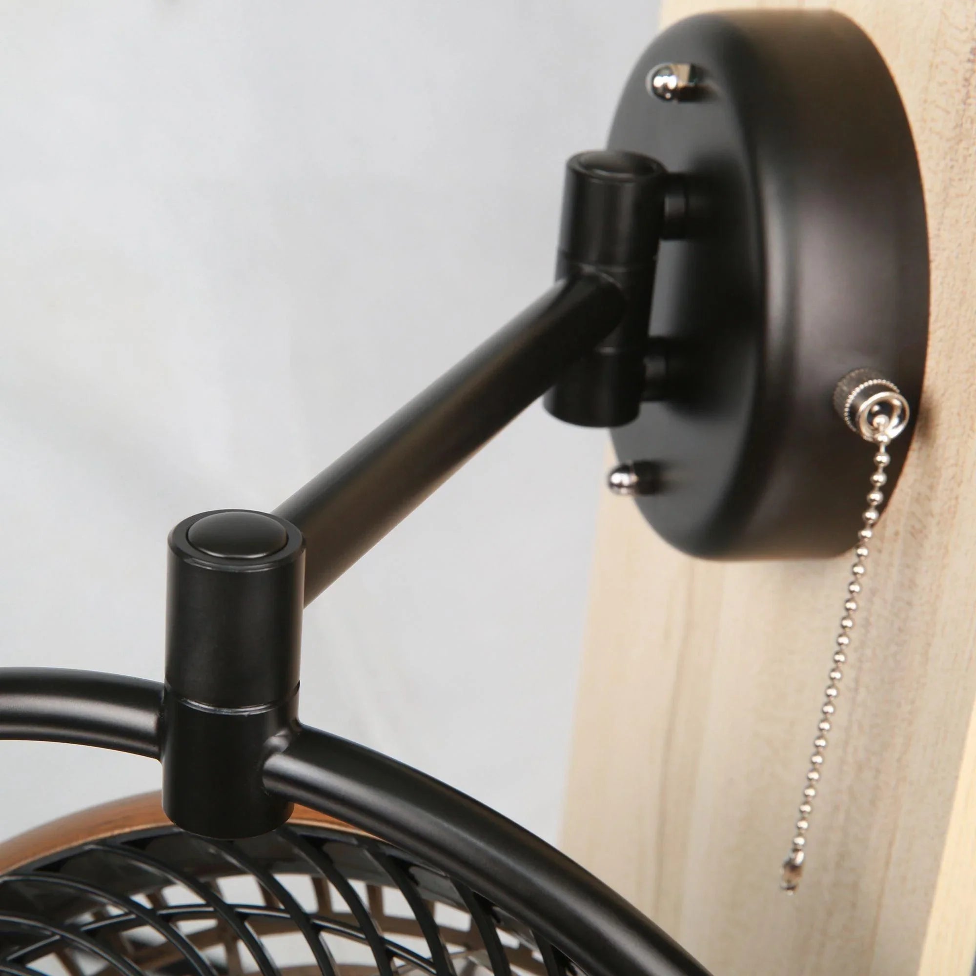 Black ceiling fan mount with pull chain and matte metal support arms