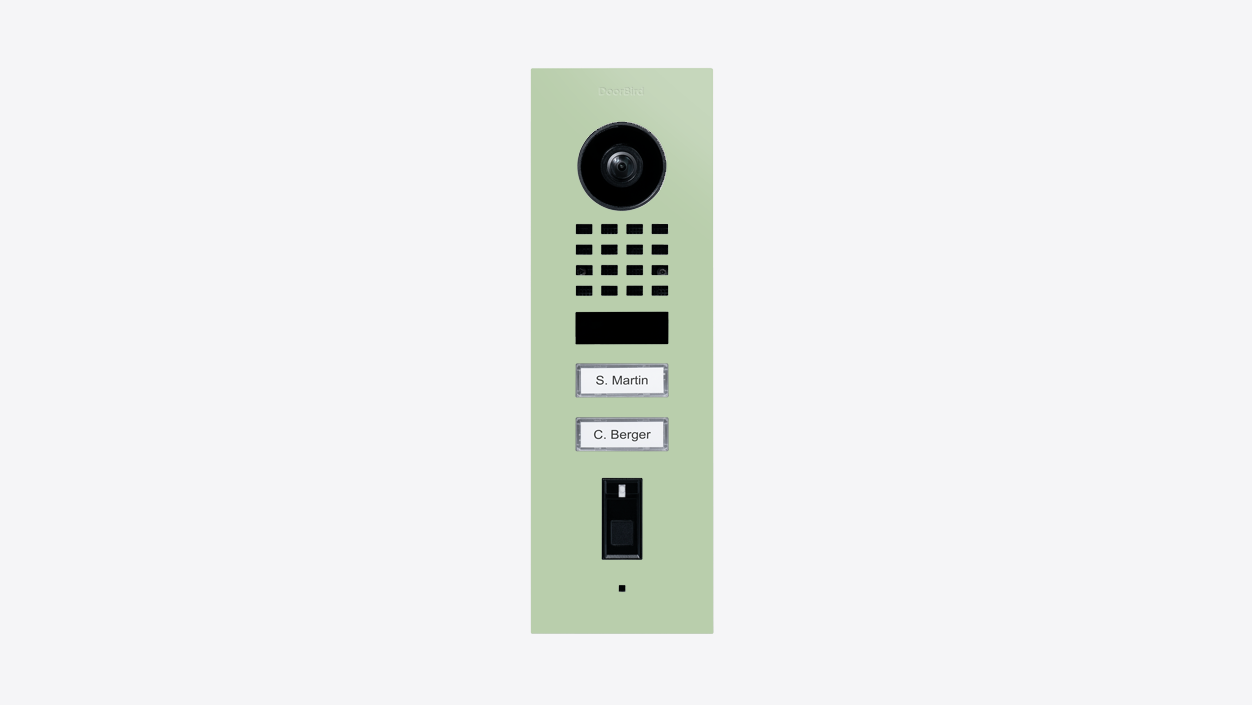 DoorBird flush-mount video door station in pastel green with camera lens, keypad, label plates