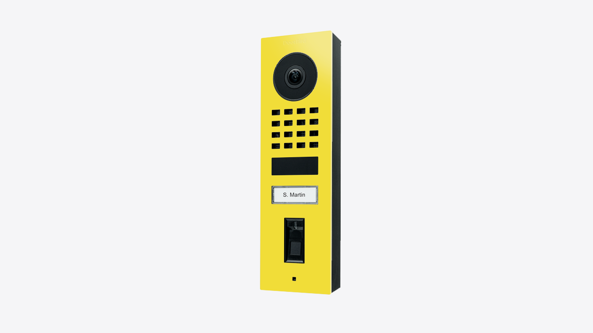 DoorBird fingerprint video door station, bright yellow front with camera and keypad