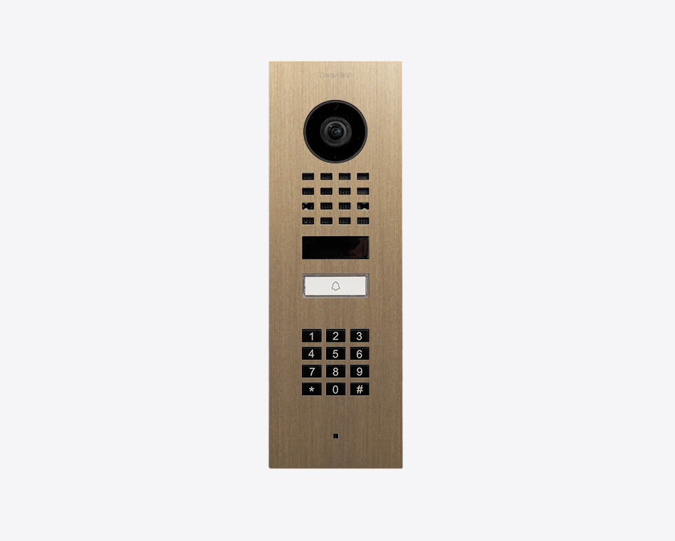 DoorBird brass video door station with camera, call button, and numeric keypad