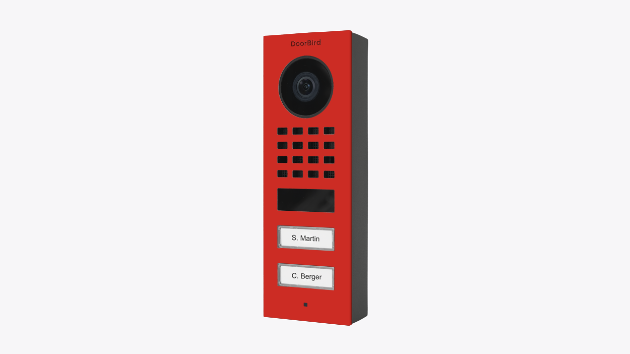 DoorBird surface-mount video door station in pure red, with camera and call buttons