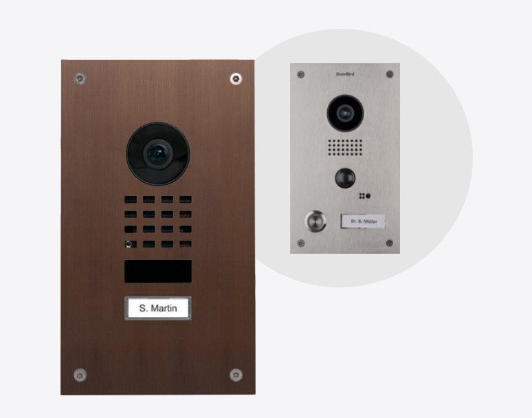 DoorBird video door station in architectural bronze with camera, speaker grille, and nameplate