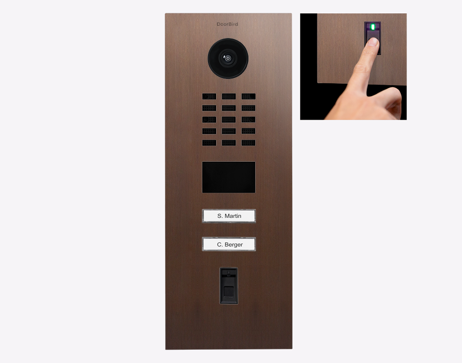 Architectural bronze video door station with camera lens, keypad grid, and speaker grille