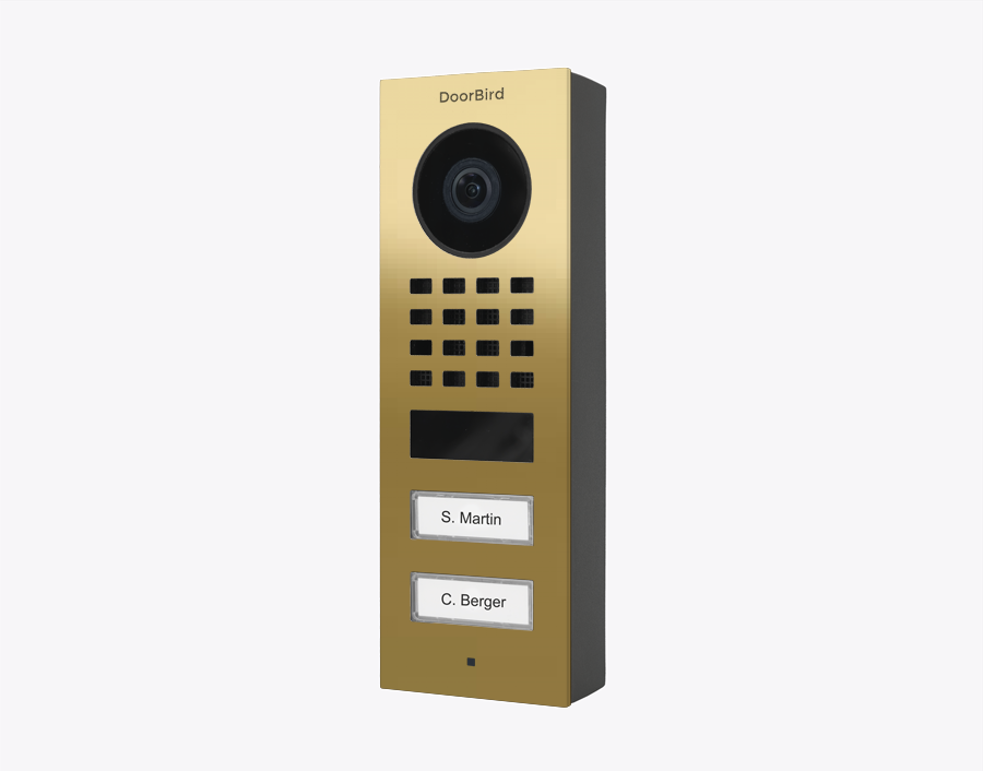 DoorBird brass surface-mount IP video door station with camera lens and call buttons