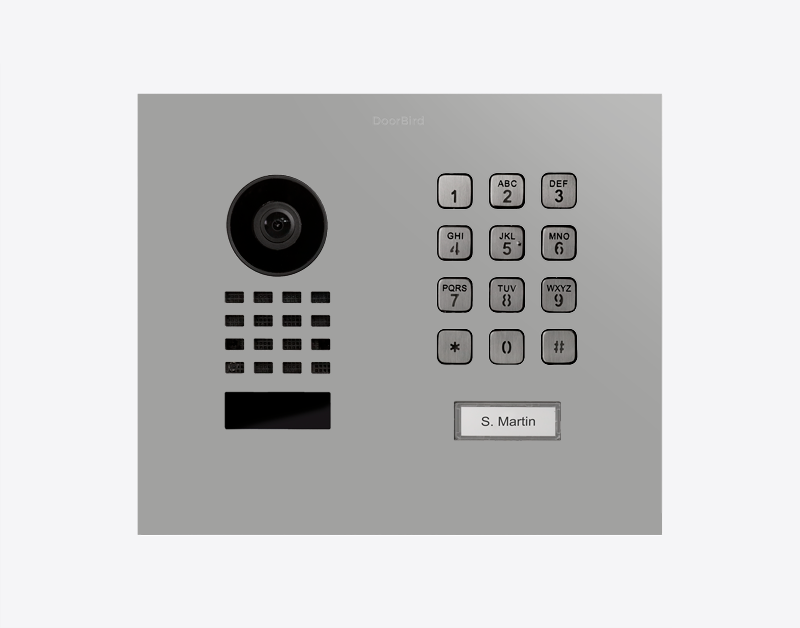 DoorBird video door station front panel with camera lens, numeric keypad, and nameplate