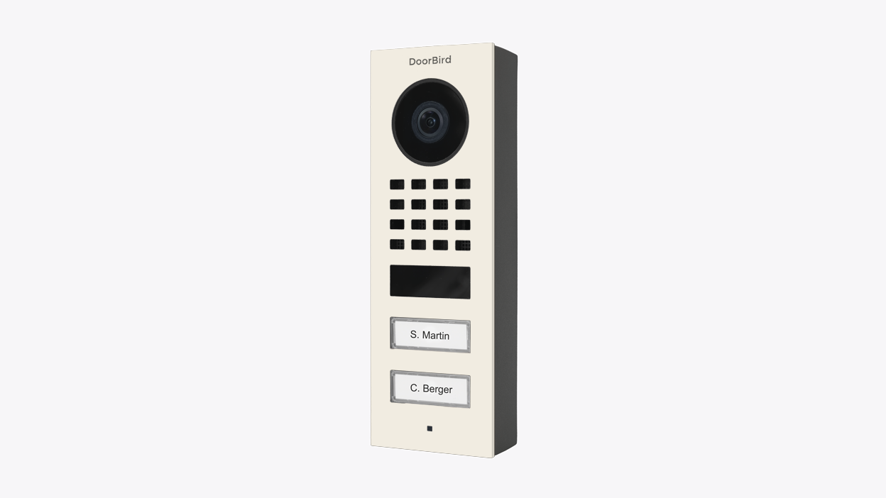 DoorBird surface-mount video door station, pure white panel with camera, grille, buttons