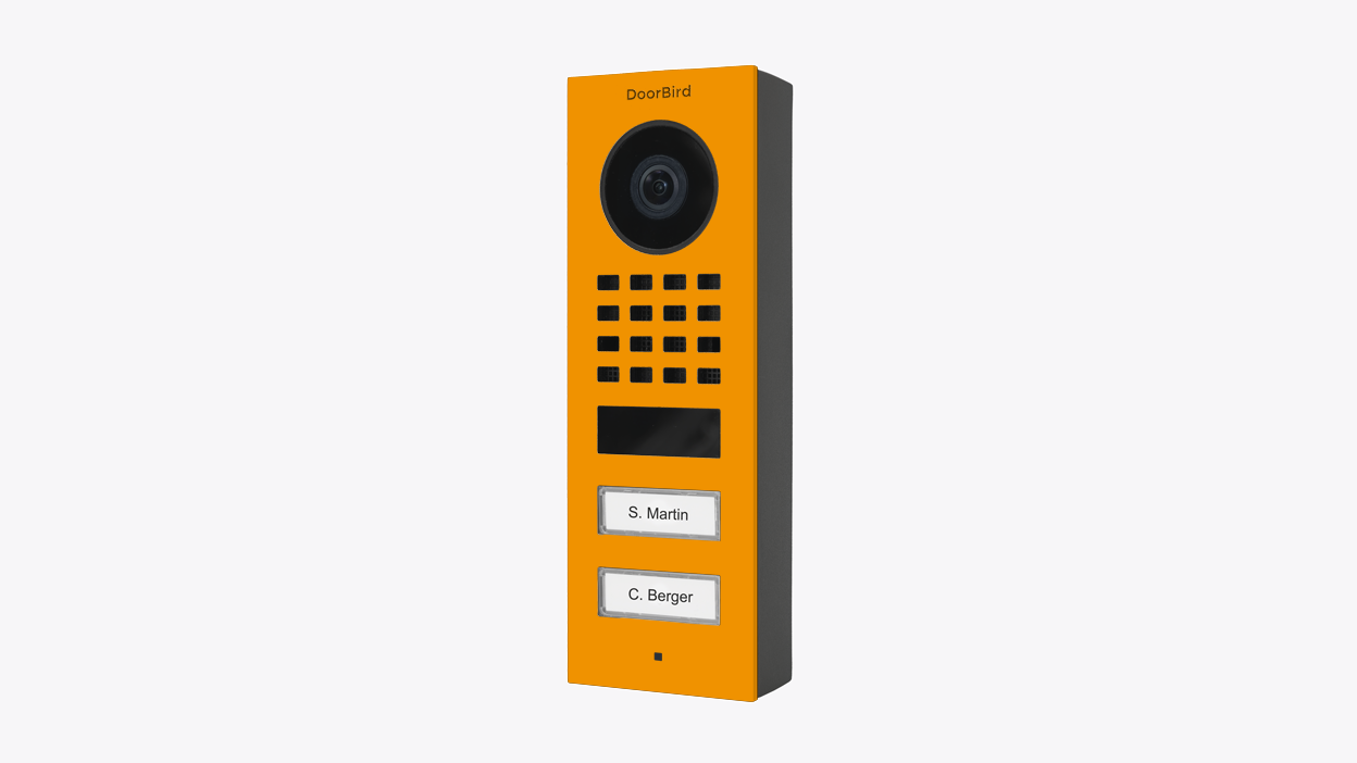DoorBird video door station in sun yellow with camera, grille, and two nameplate buttons