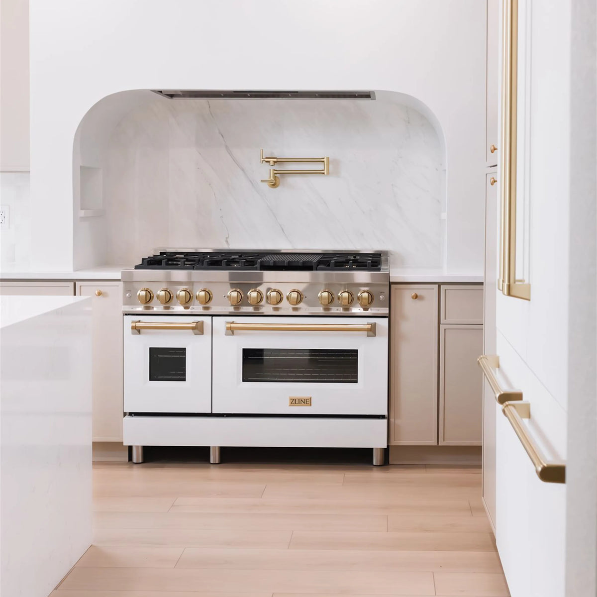ZLINE Legacy Series Autograph Edition 48-inch Dual Fuel Range with Gas Stove and 6.0 Cu. Ft. Electric Oven in Stainless Steel with White Matte Door and Champagne Bronze Accents in a kitchen