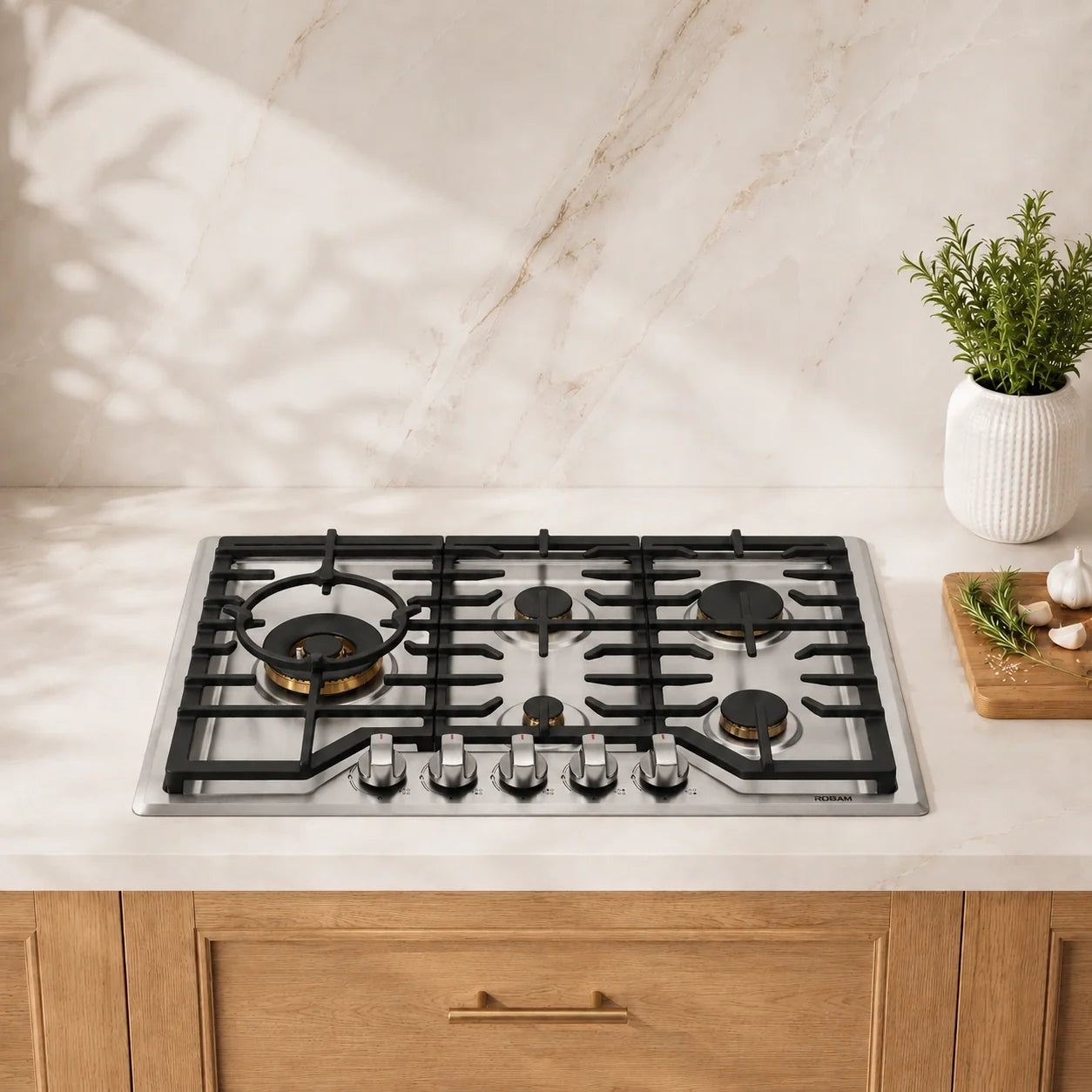 Stainless 5-burner gas cooktop with black cast-iron grates and control knobs.