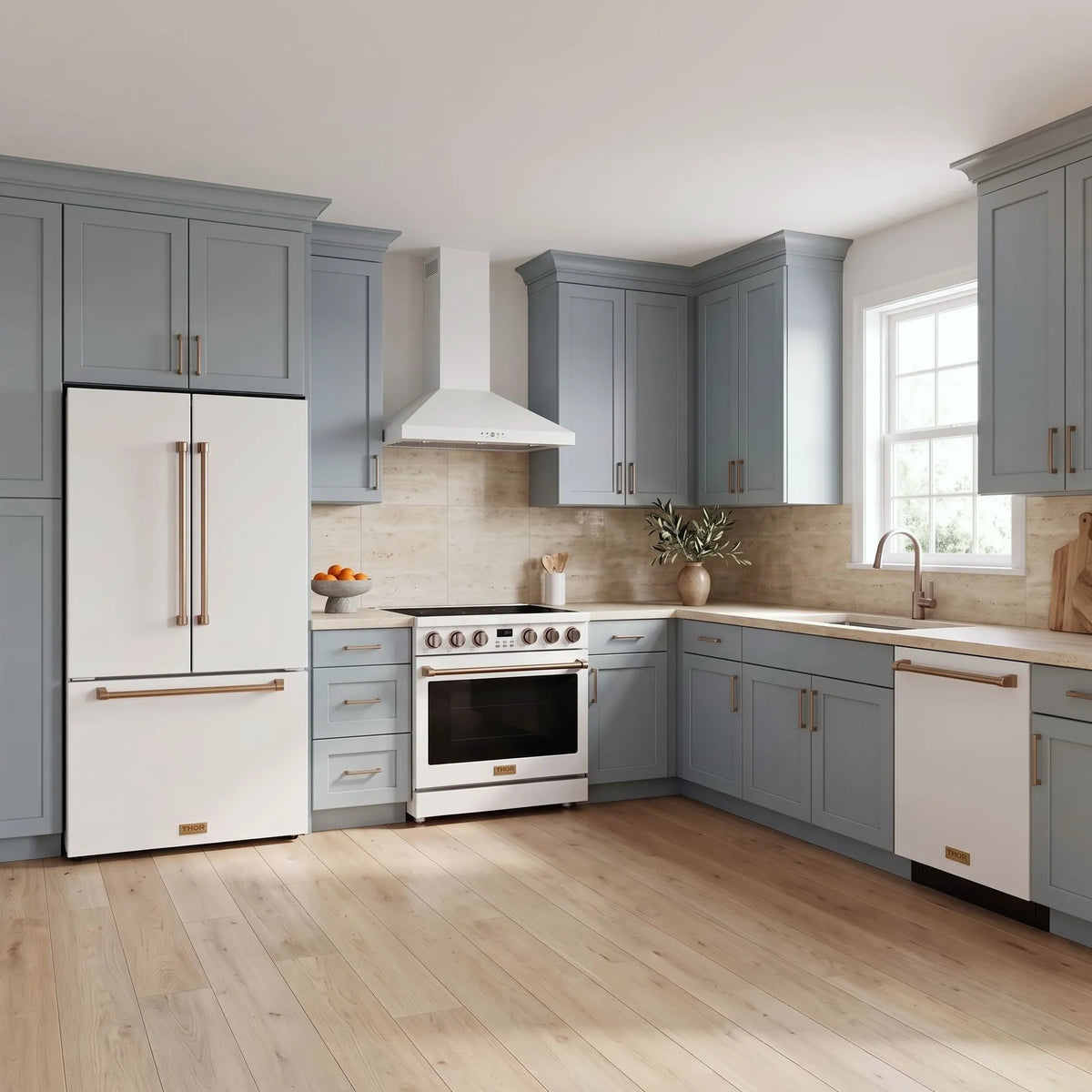 Thor Kitchen A-Series white and bronze kitchen with a 36-inch electric range, wall-mount chimney hood, French door refrigerator, dishwasher