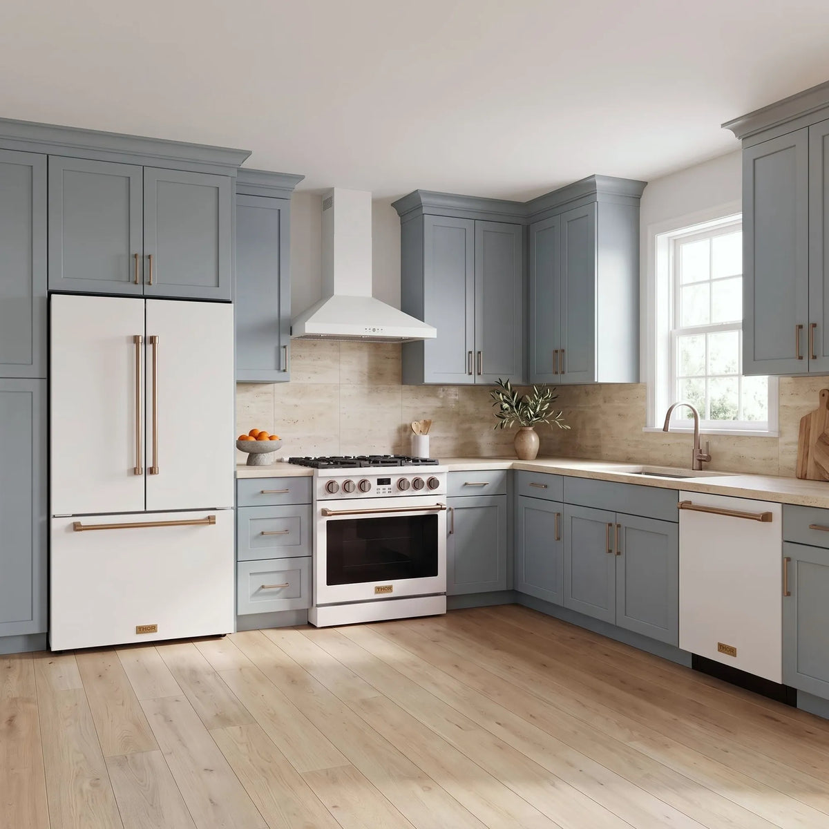 Thor Kitchen A-Series white and bronze kitchen with a 36-inch gas range, wall-mount chimney hood, French door refrigerator, dishwasher