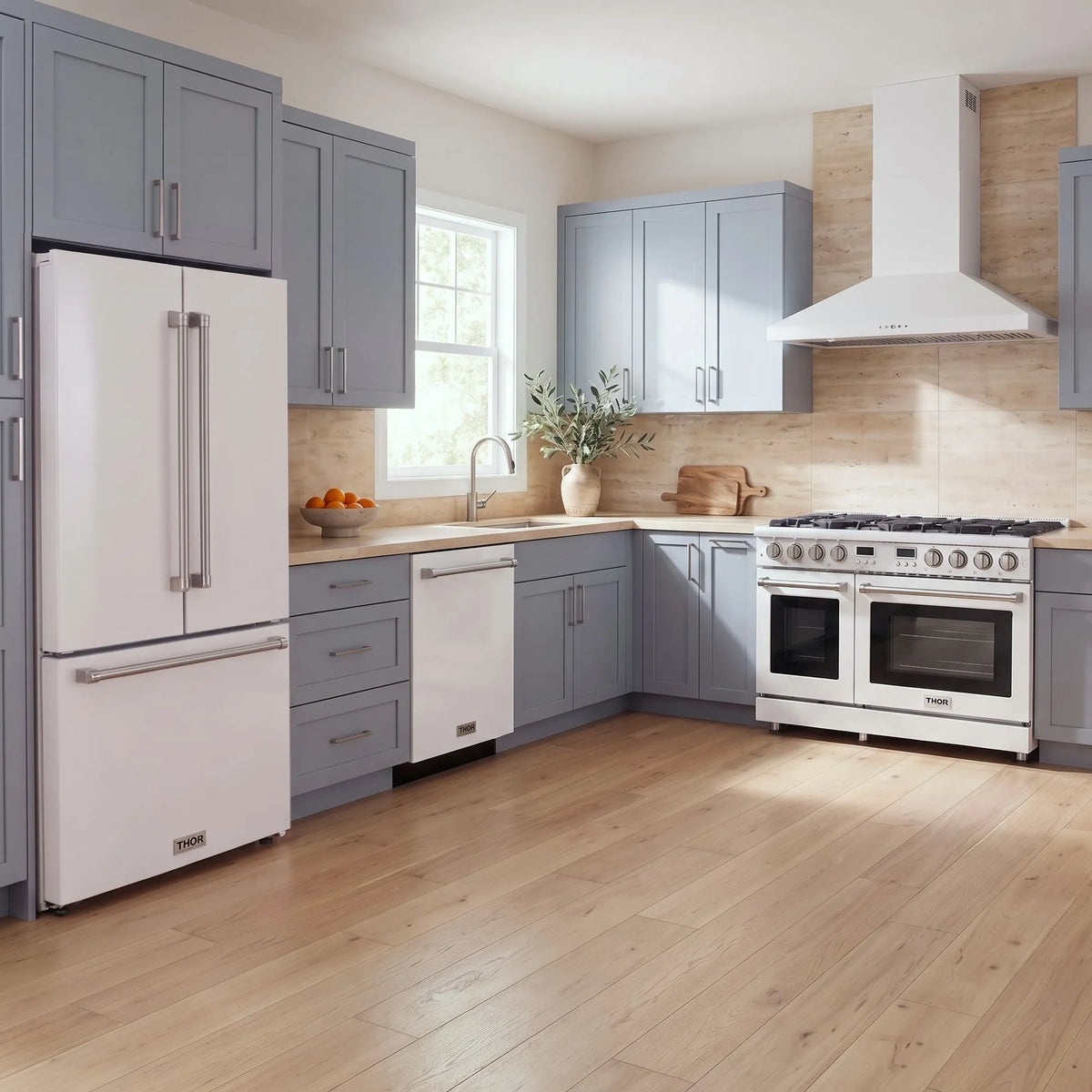 Thor Kitchen A-Series white kitchen with a 48-inch gas range, wall-mount chimney hood, French door refrigerator, dishwasher