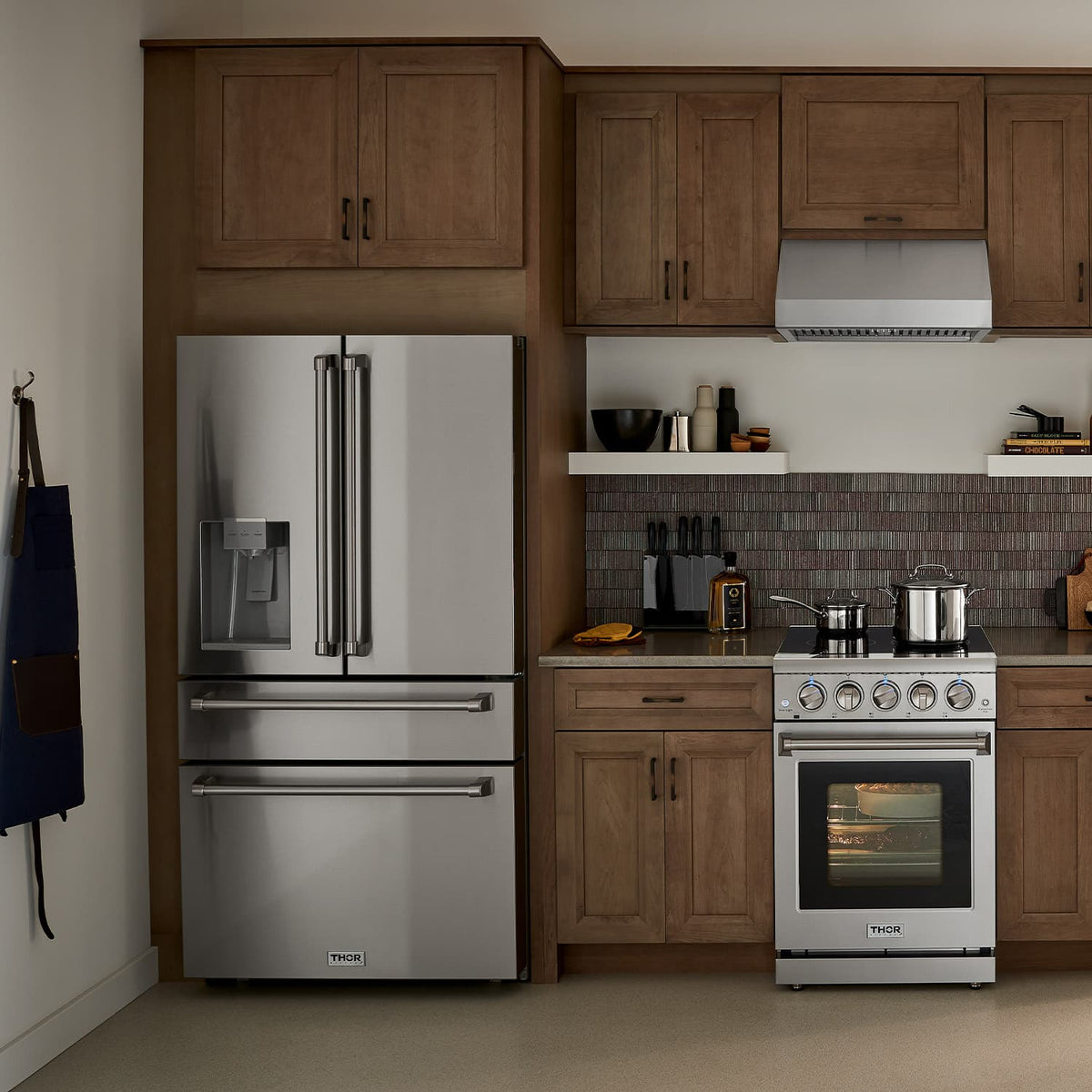 Stainless steel French door refrigerator with water dispenser, installed in kitchen