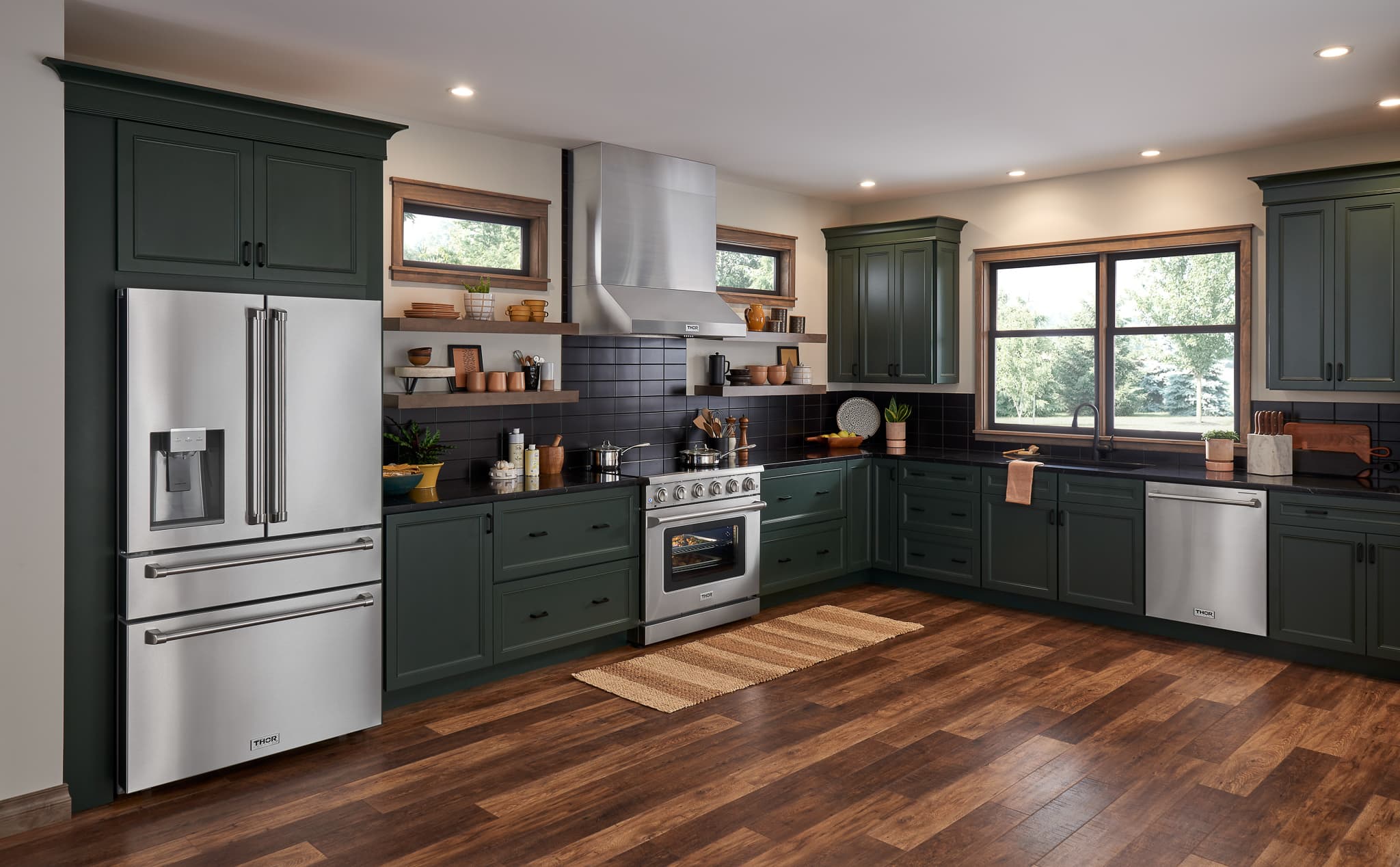 Stainless steel French door refrigerator with water dispenser in kitchen setting