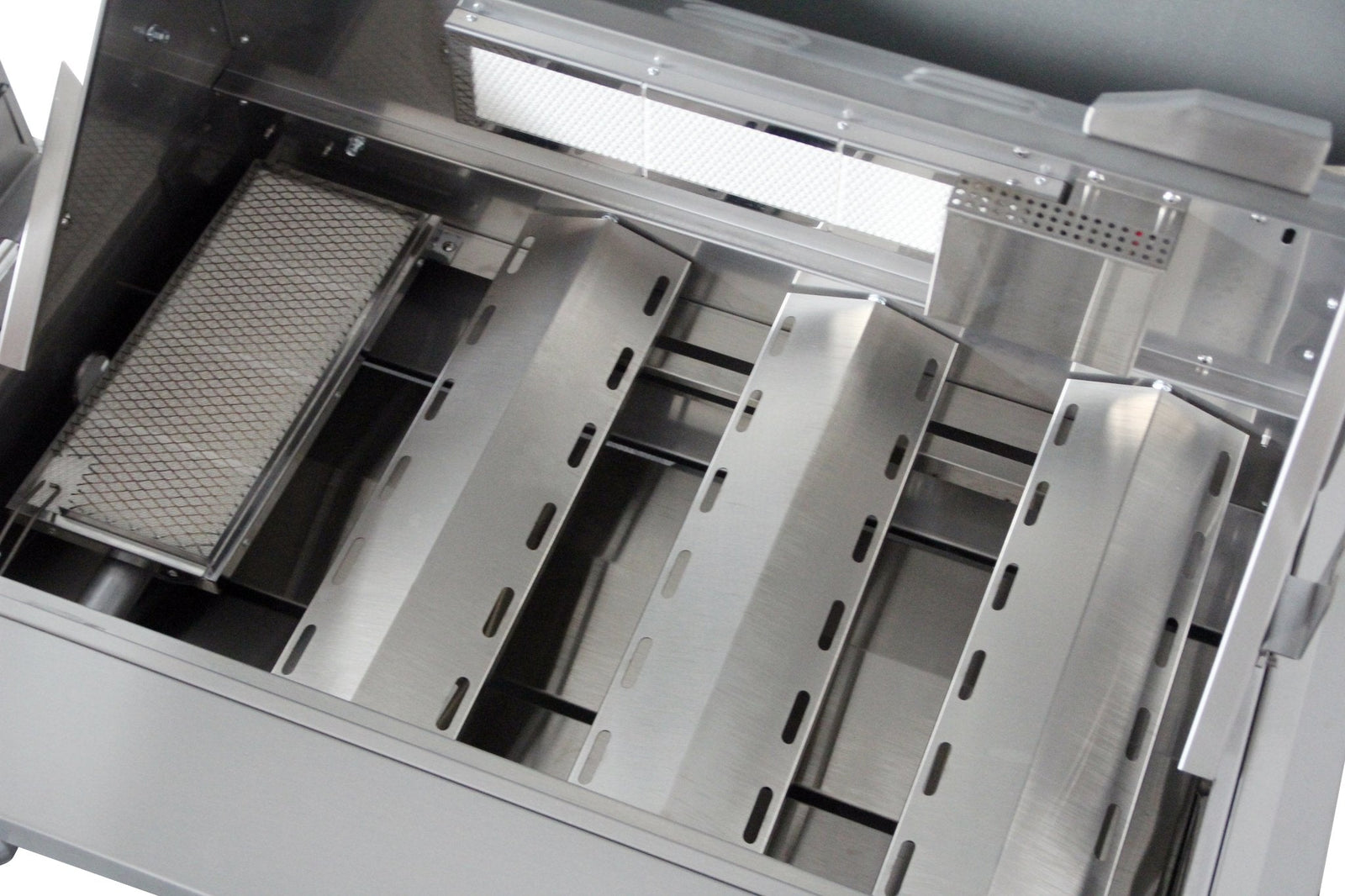 Outdoor gas grill interior with stainless heat tents and burner access panels