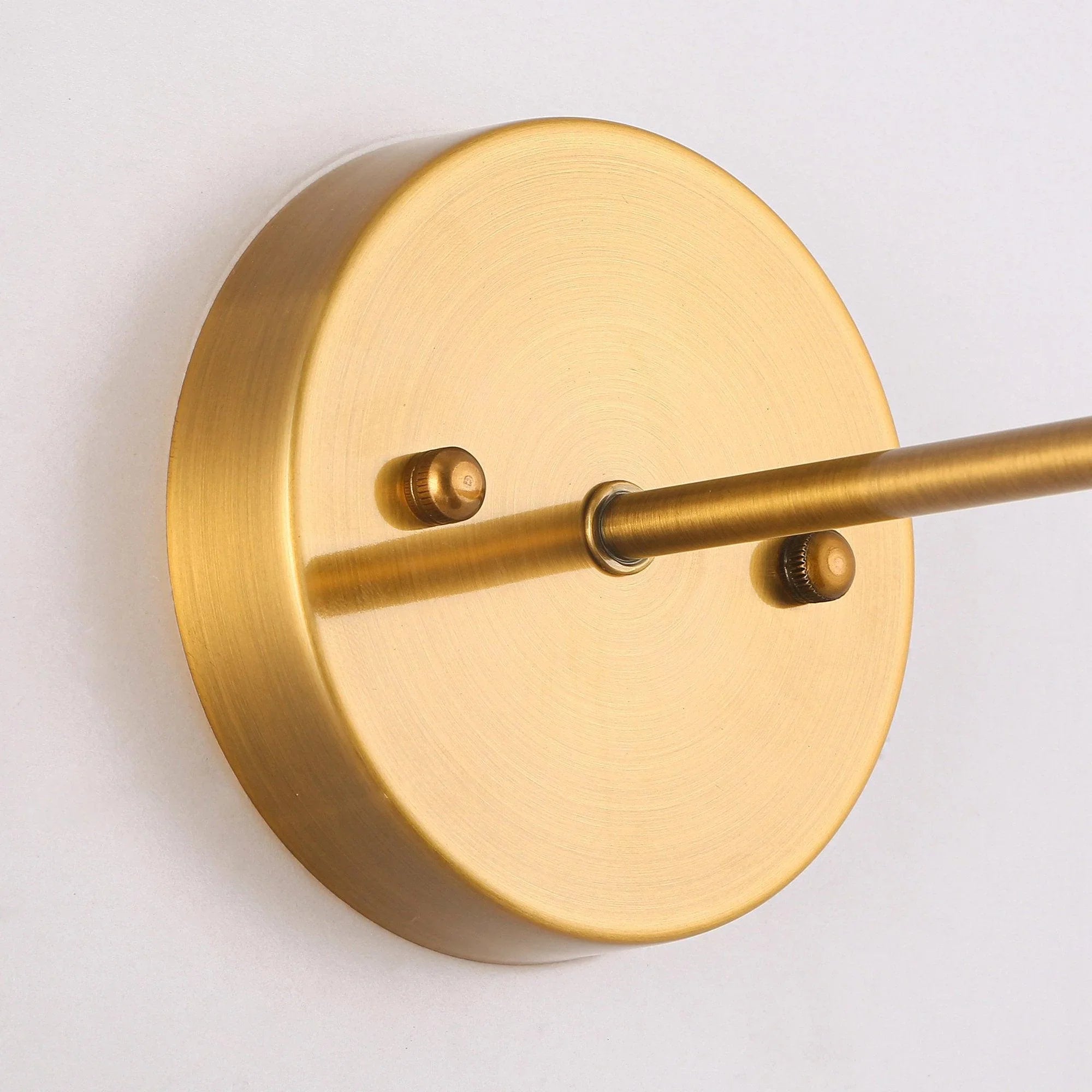 Golden round wall backplate with two mounting studs and arm connection for wall light