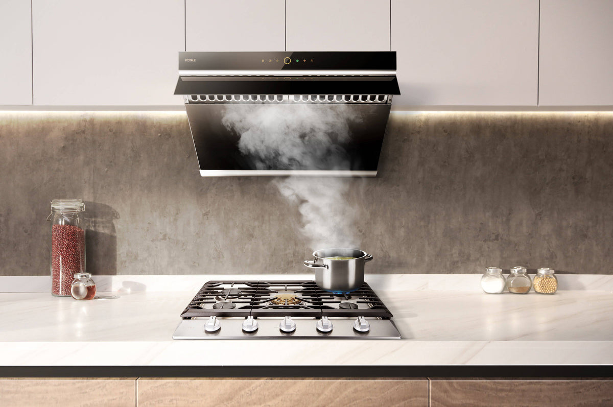 Stainless steel gas cooktop on countertop with black grates and multiple burners visible