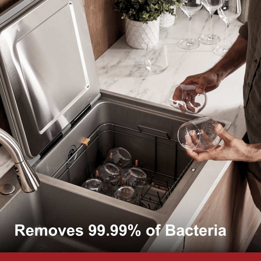 In-sink dishwasher with stainless interior, open door, and person loading dishes