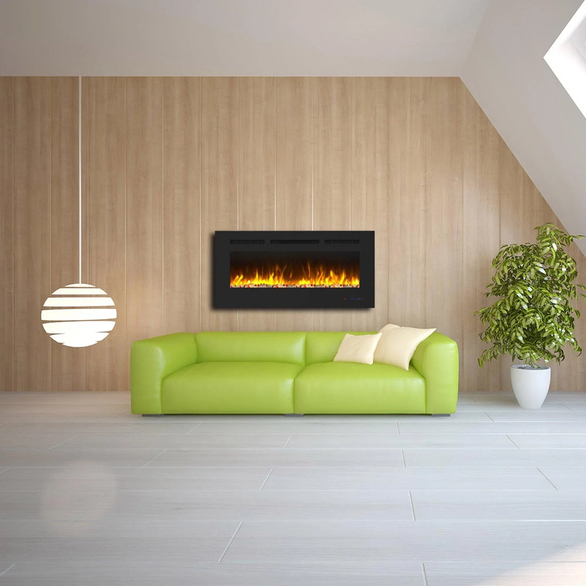 Black electric fireplace with orange flame effect mounted behind a green sofa
