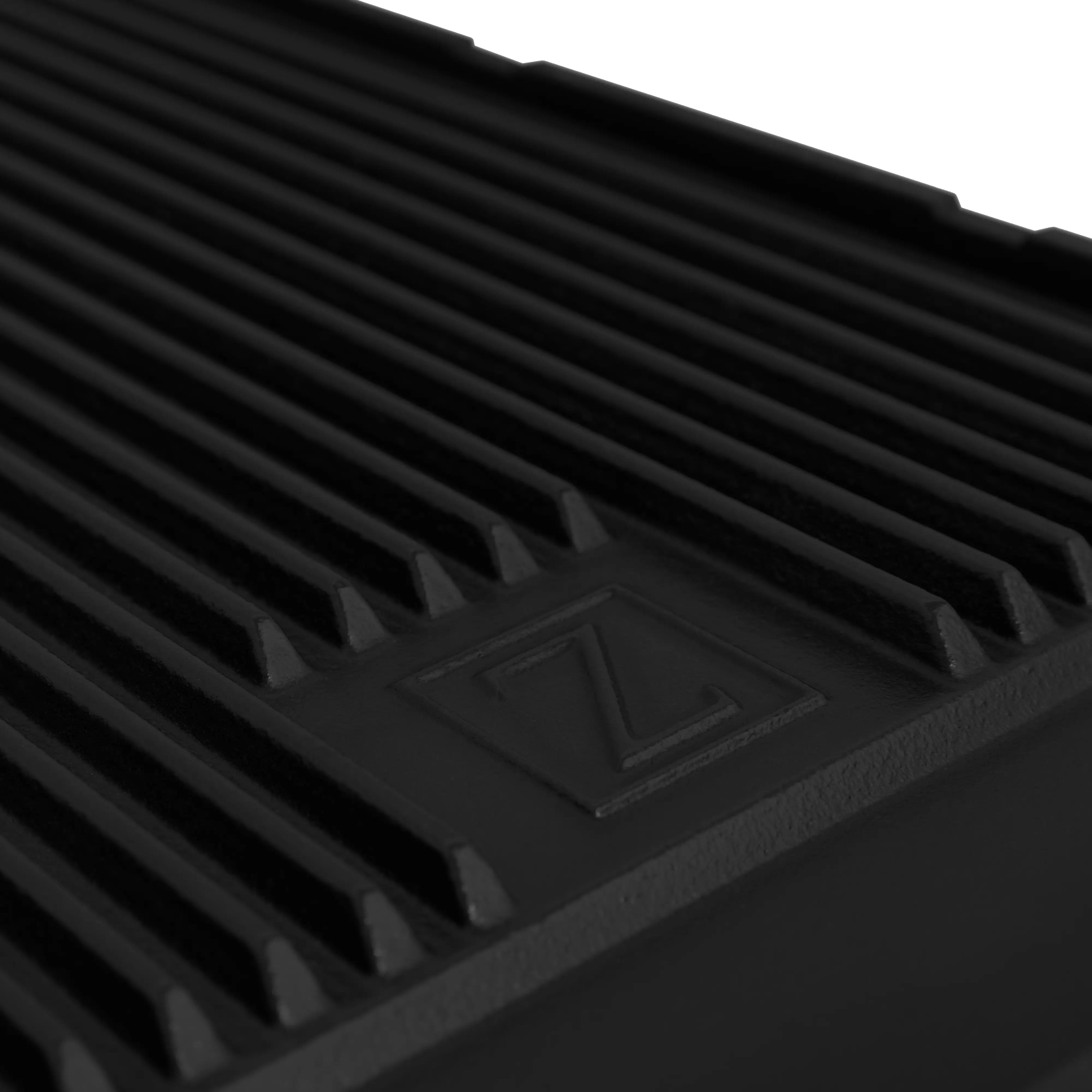 Black ridged griddle surface with central emblem on a dual fuel range.