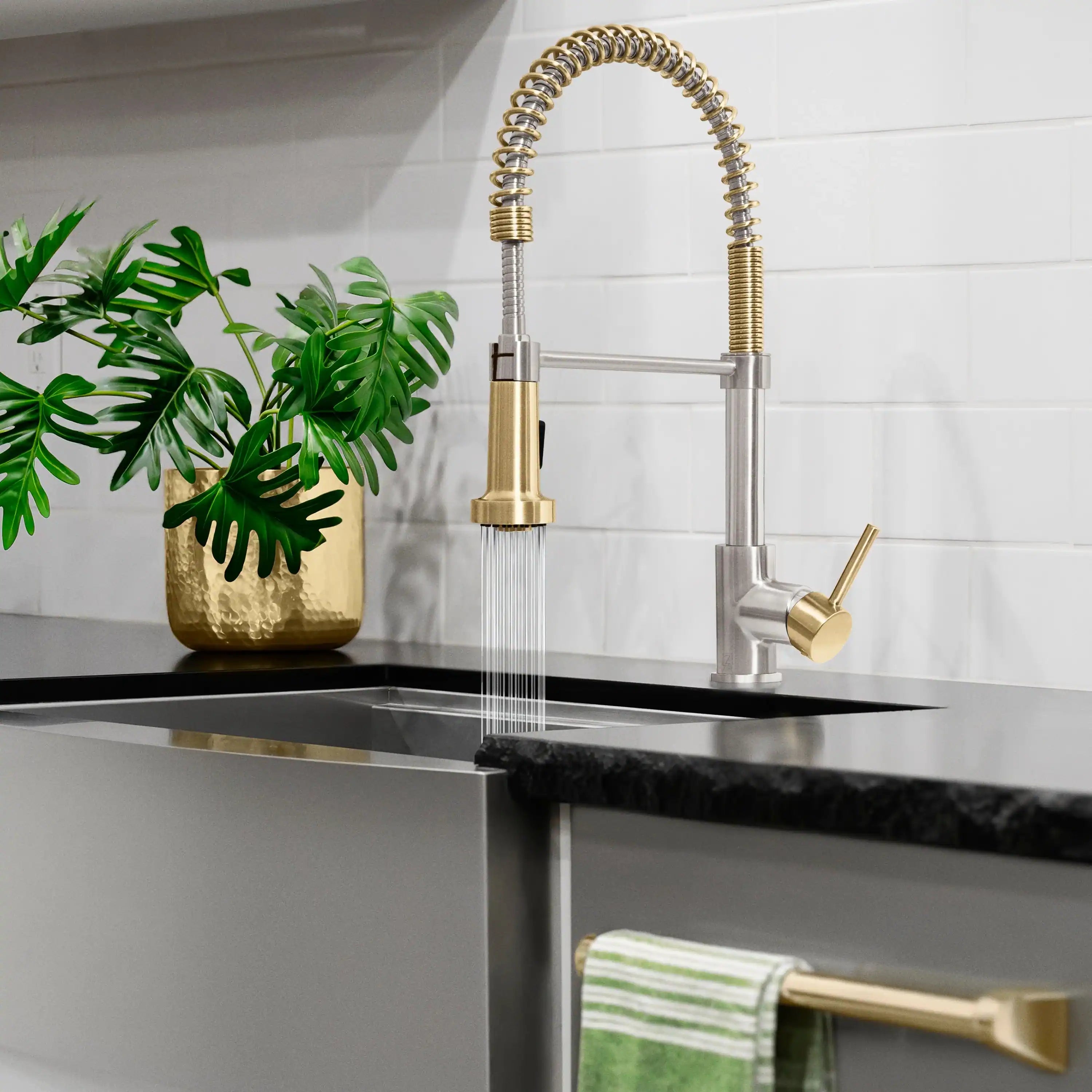 Pull-down kitchen faucet with champagne bronze lever and coiled spring hose