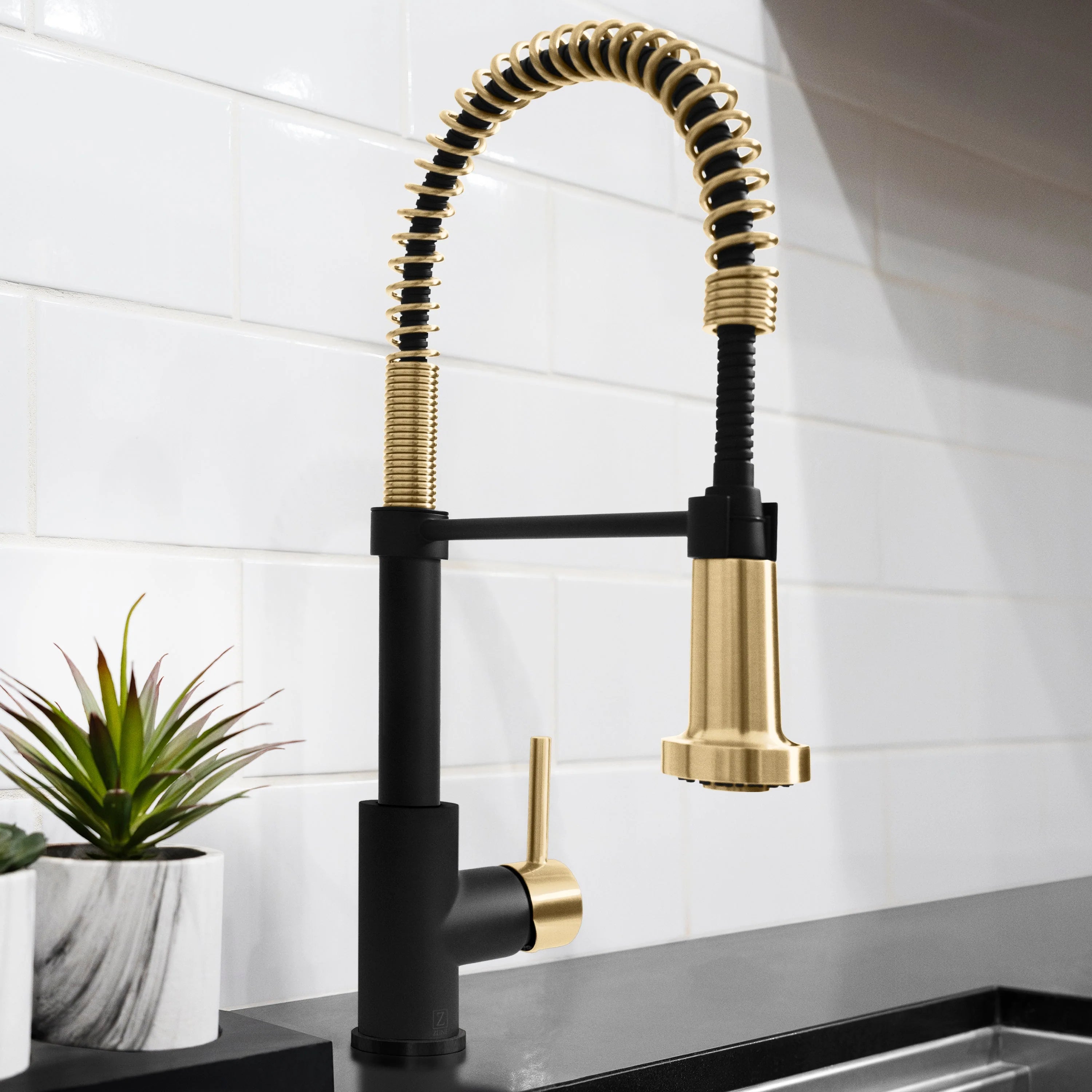 Pull-down kitchen faucet with matte black body and champagne bronze flexible hose