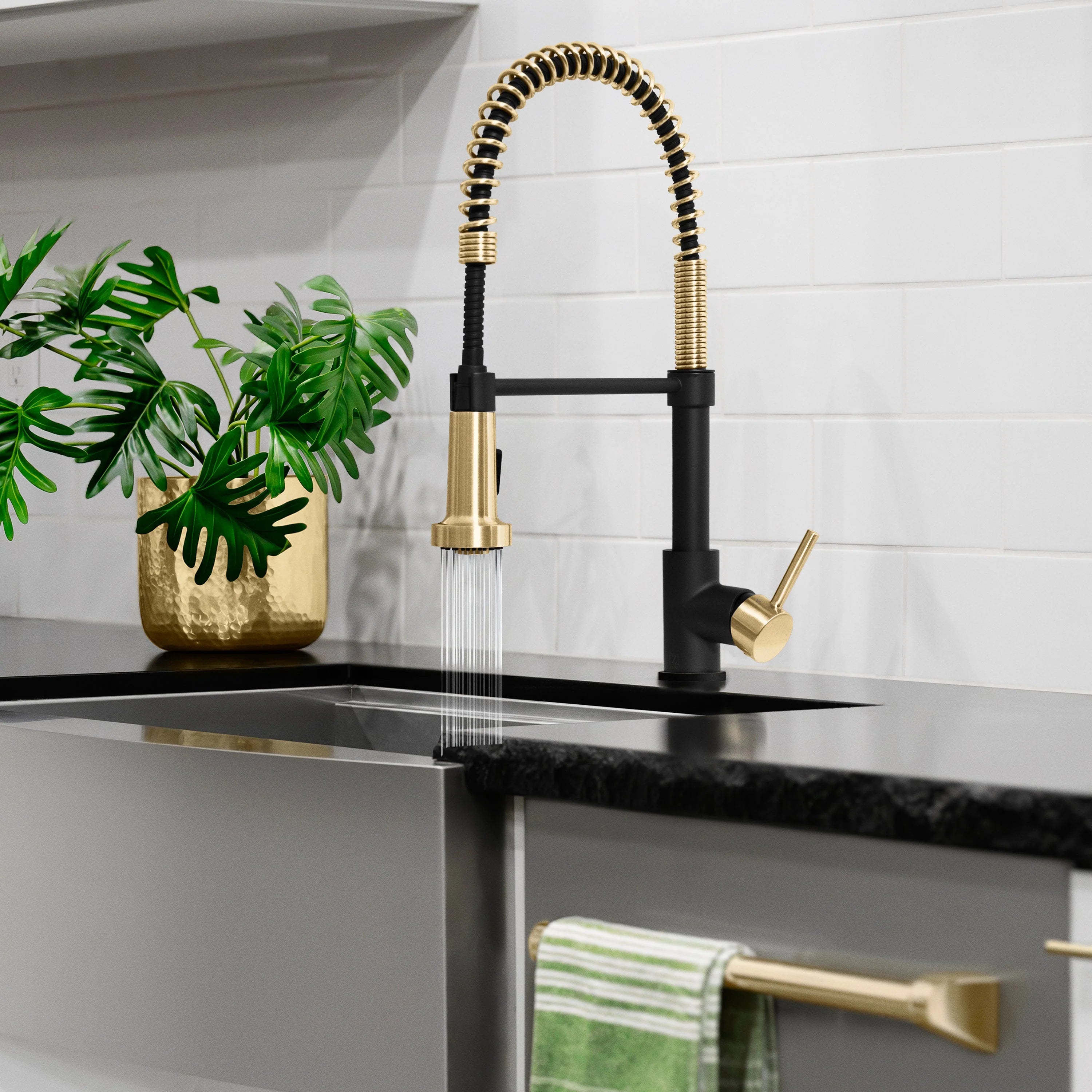 Kitchen faucet set with matte black handles and champagne bronze pull-down spout