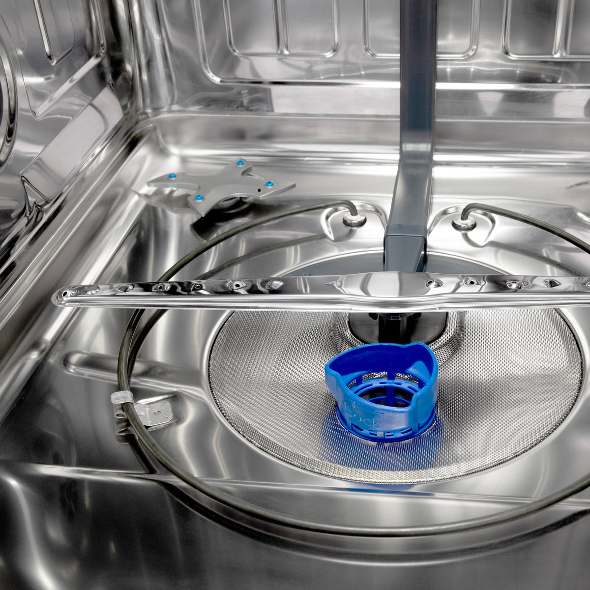 Stainless steel dishwasher wash area with circular spray cover and blue rinse cup