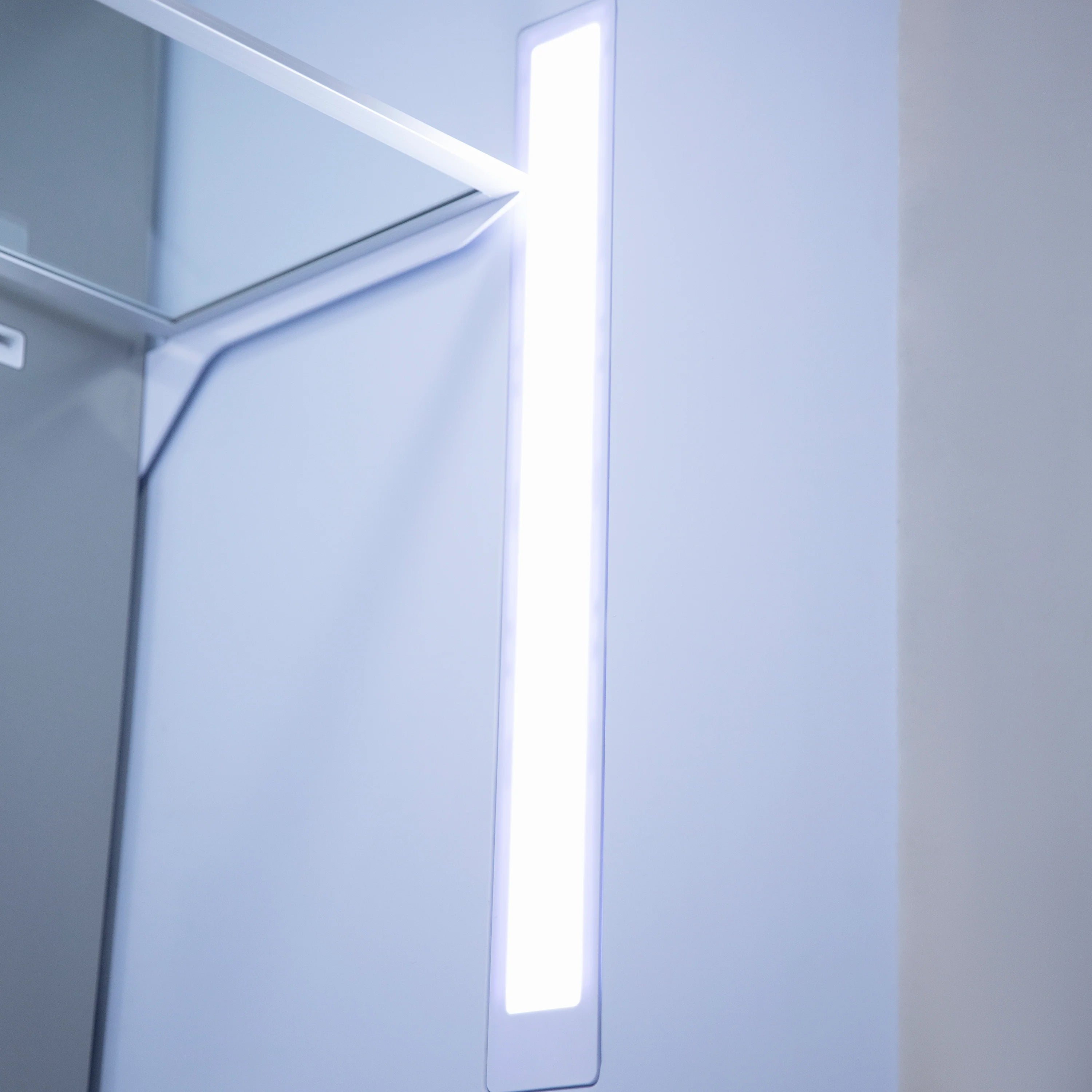 Built-in refrigerator interior with bright vertical LED light and closed compartments