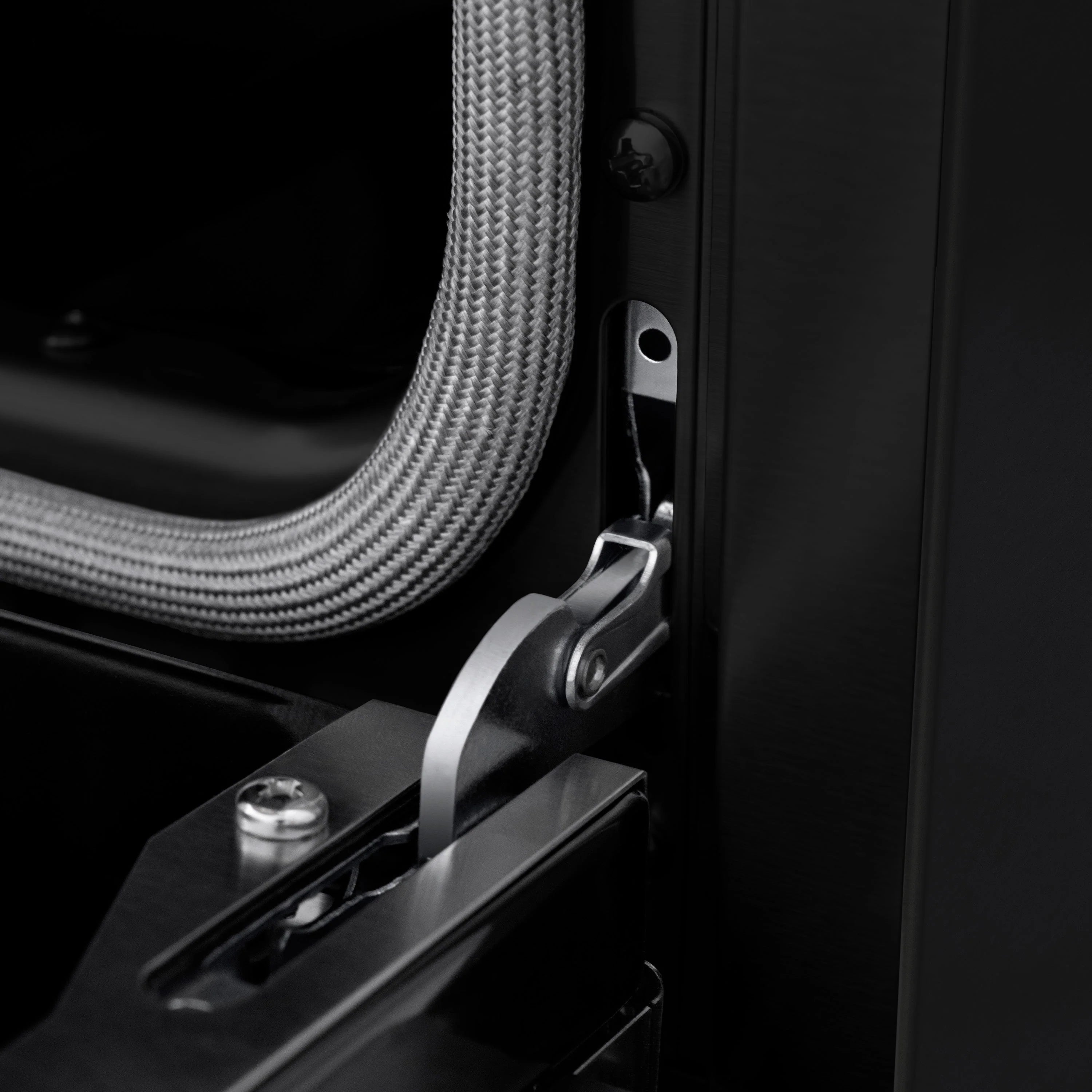 Black control door handle with gold-accented lever on dual fuel range
