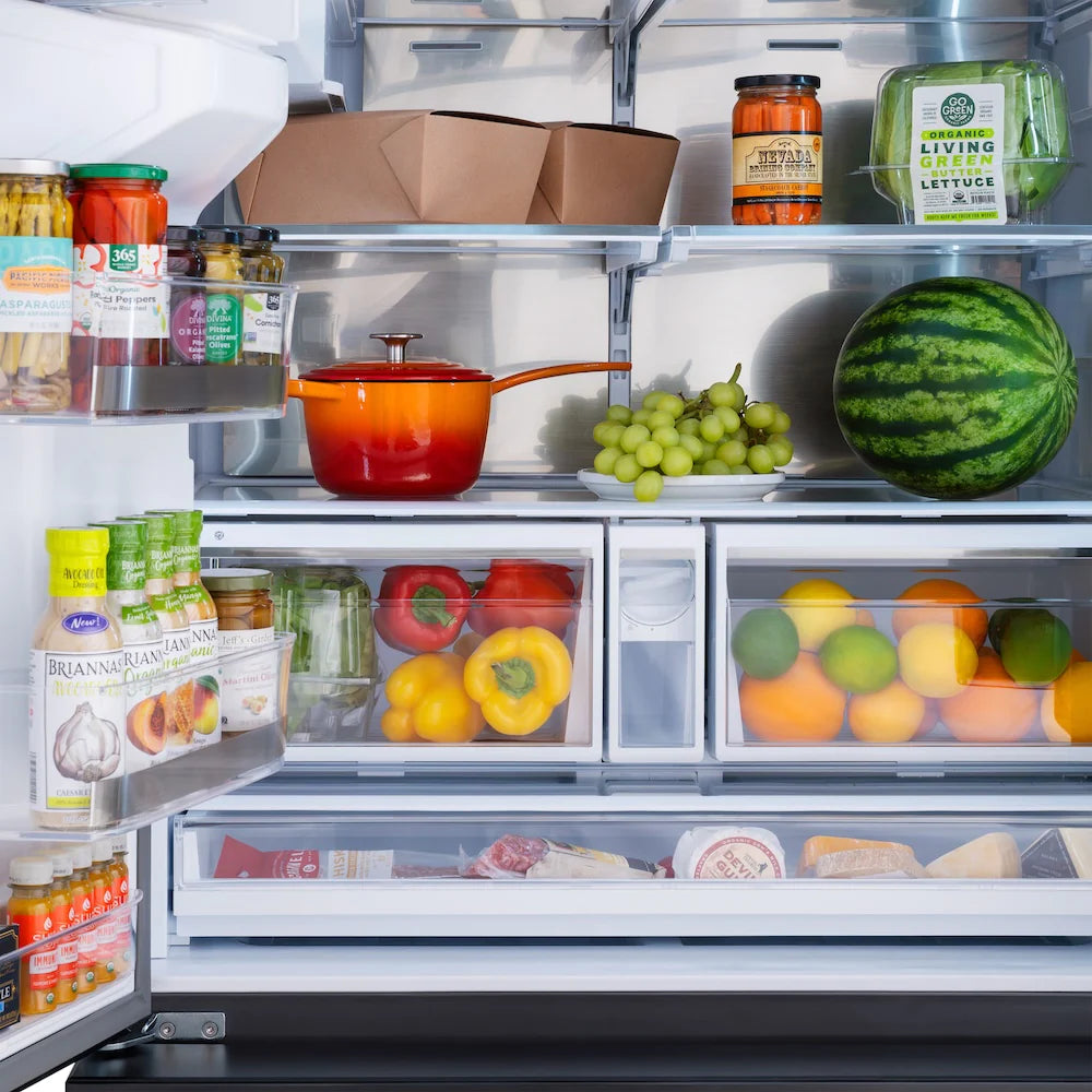 Open refrigerator interior with shelves, produce, and food containers