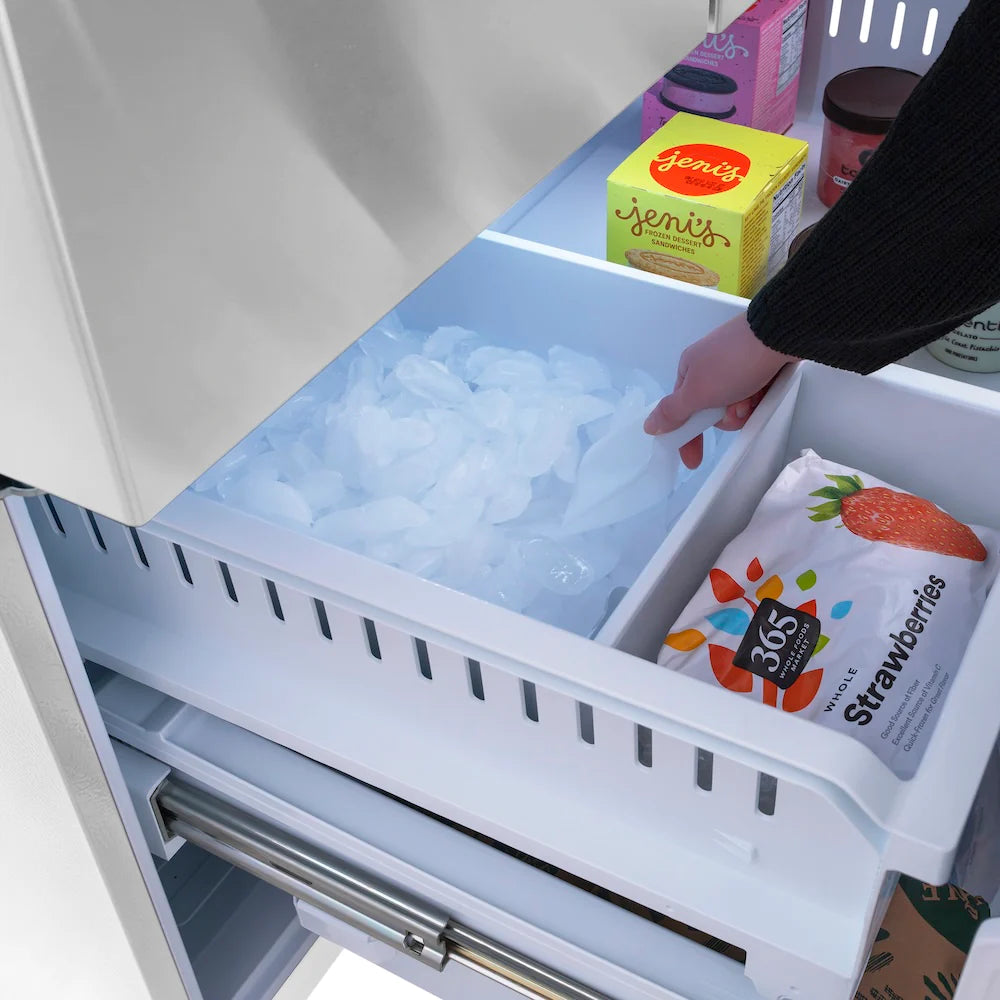 Refrigerator freezer drawer with ice bin filled with ice cubes