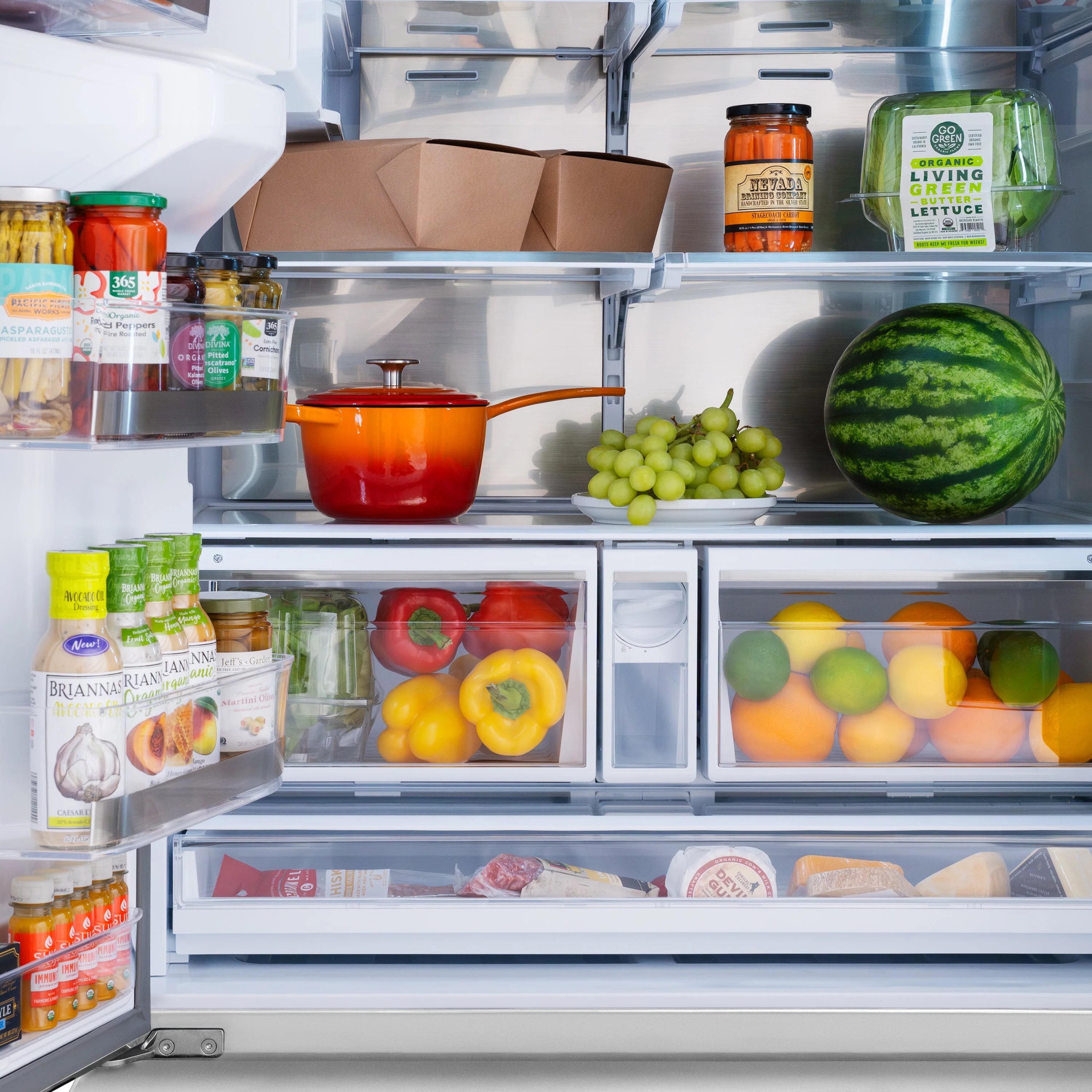 Refrigerator interior with glass shelves and stored groceries