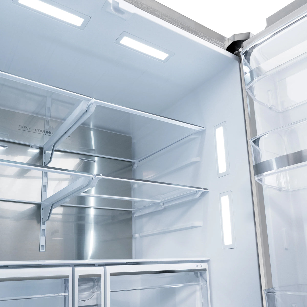 Refrigerator interior with shelves and cold air ducts; open door view