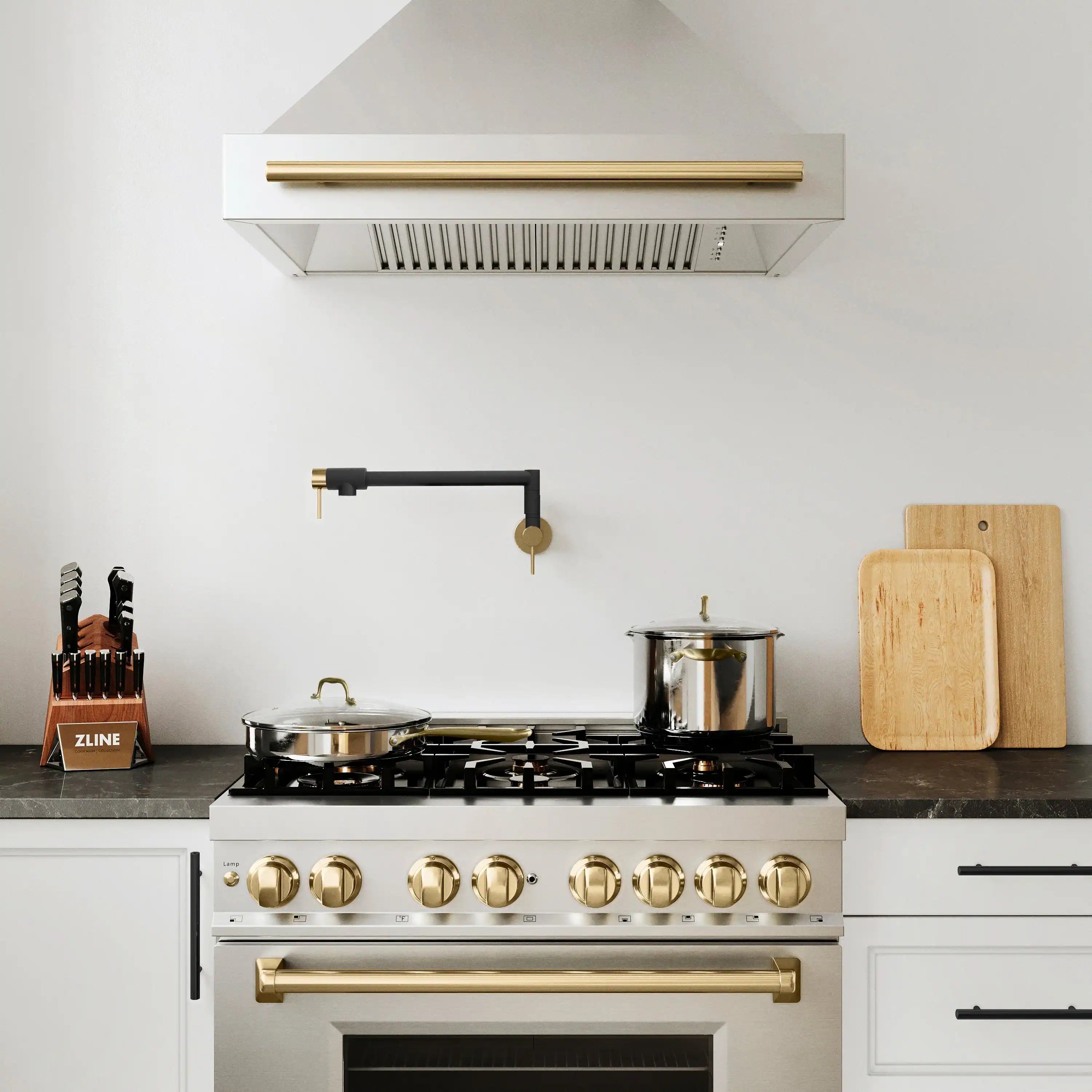 Pot filler faucet with matte black pipes and champagne bronze fittings above cooktop.