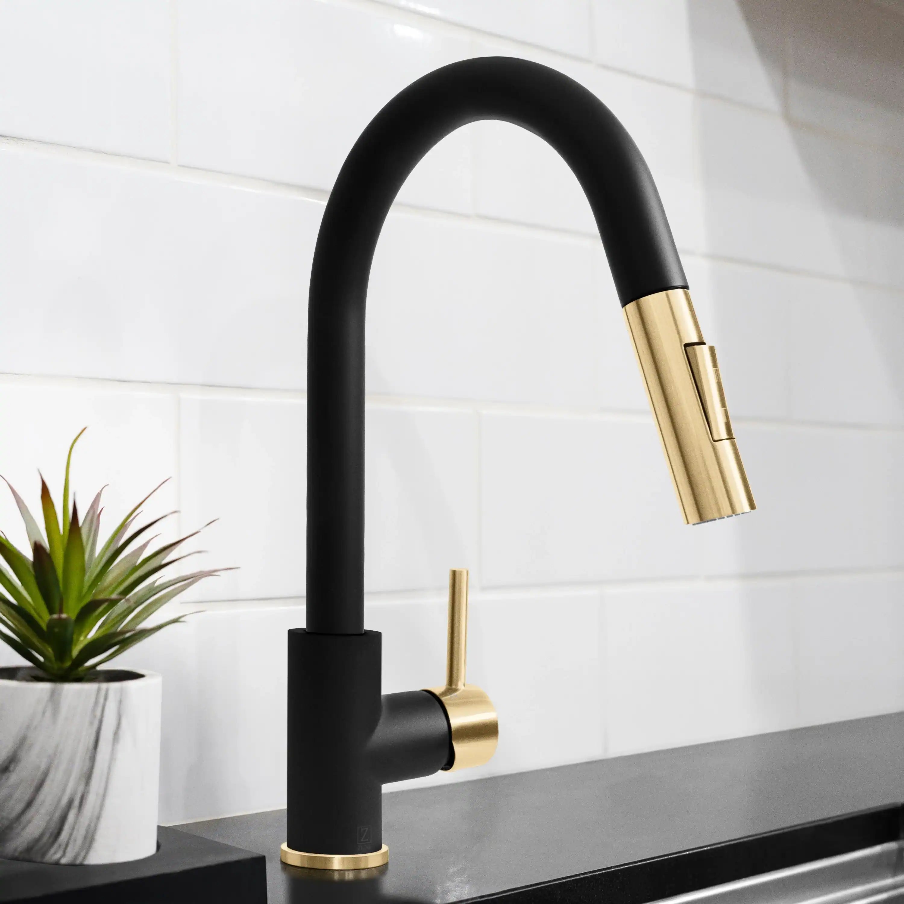 Matte black single-handle kitchen faucet with champagne bronze pull-down spout
