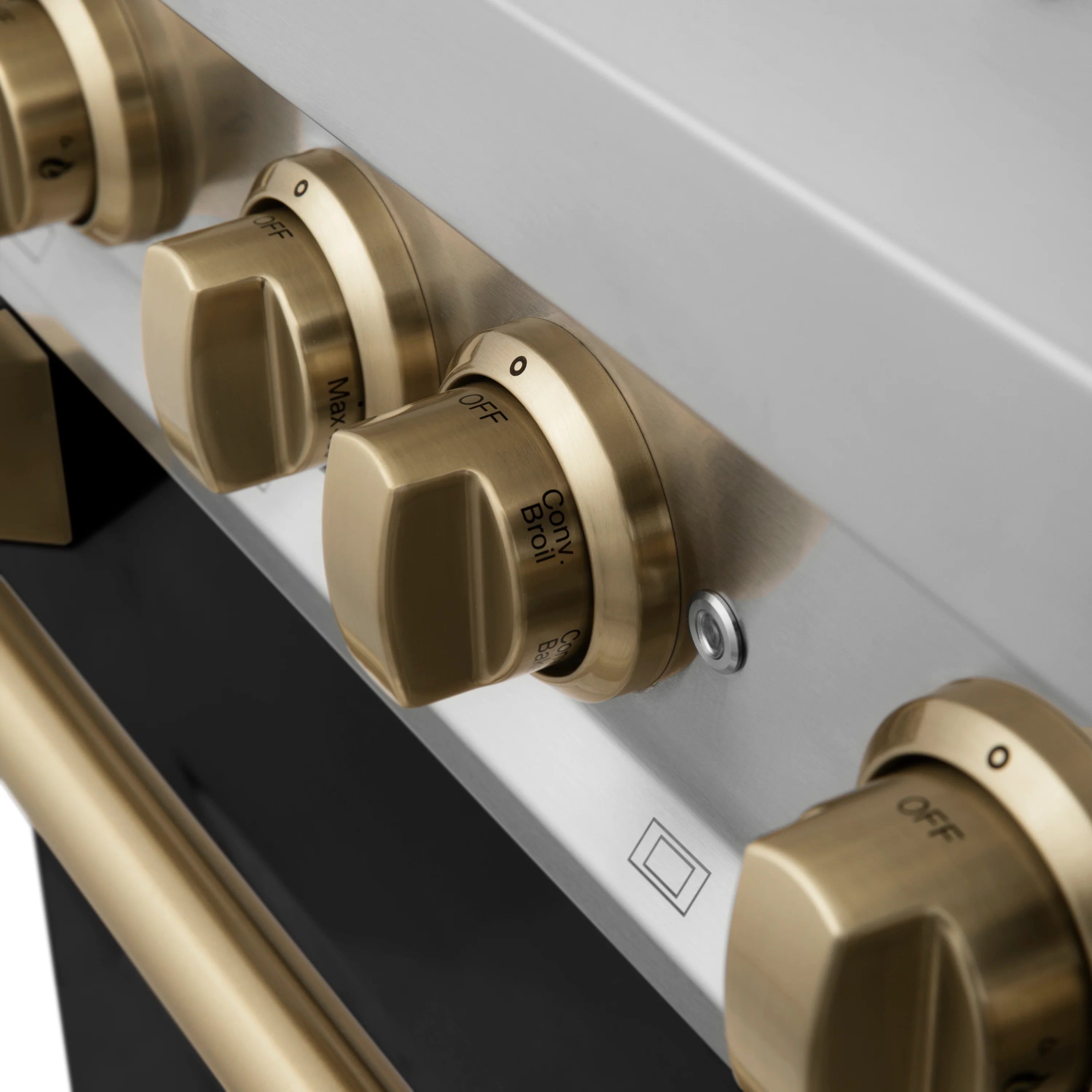 Champagne bronze gas control knobs on stainless range front panel