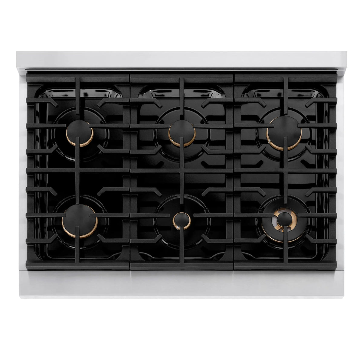Cooktop view showing multiple gas burners with black grates and champagne bronze accents