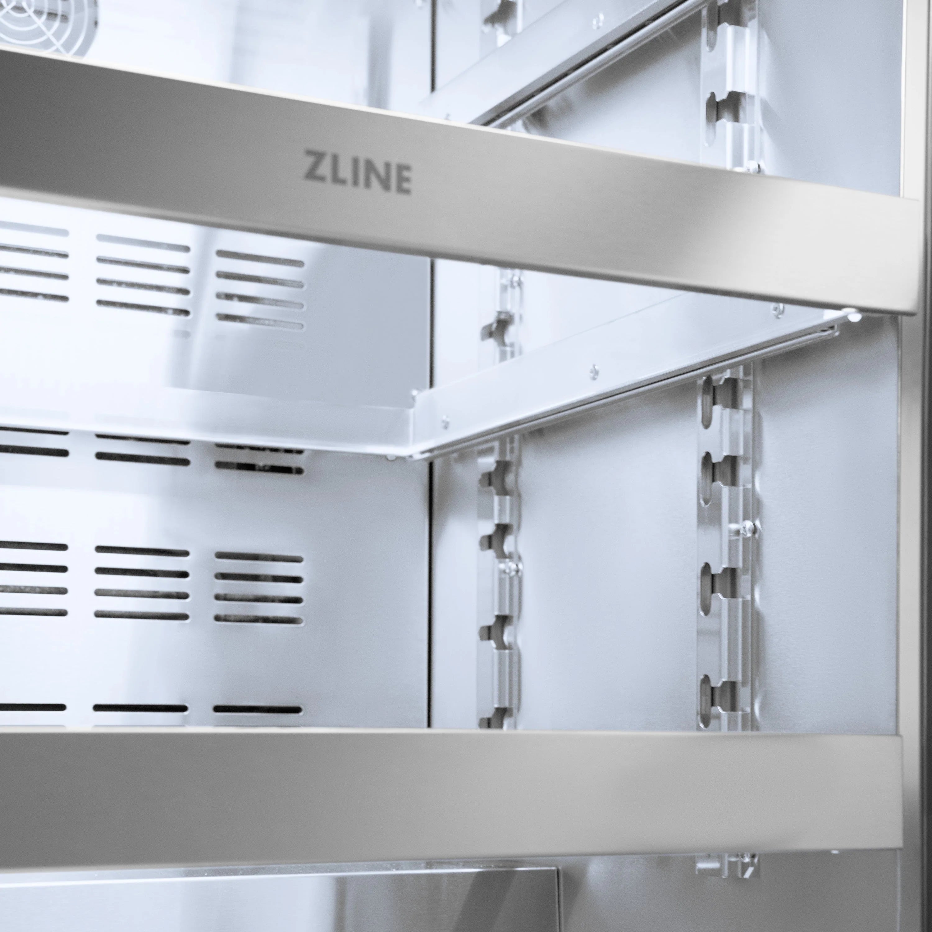 Wine cooler door interior with hinges and side rack supports, vented silver panels