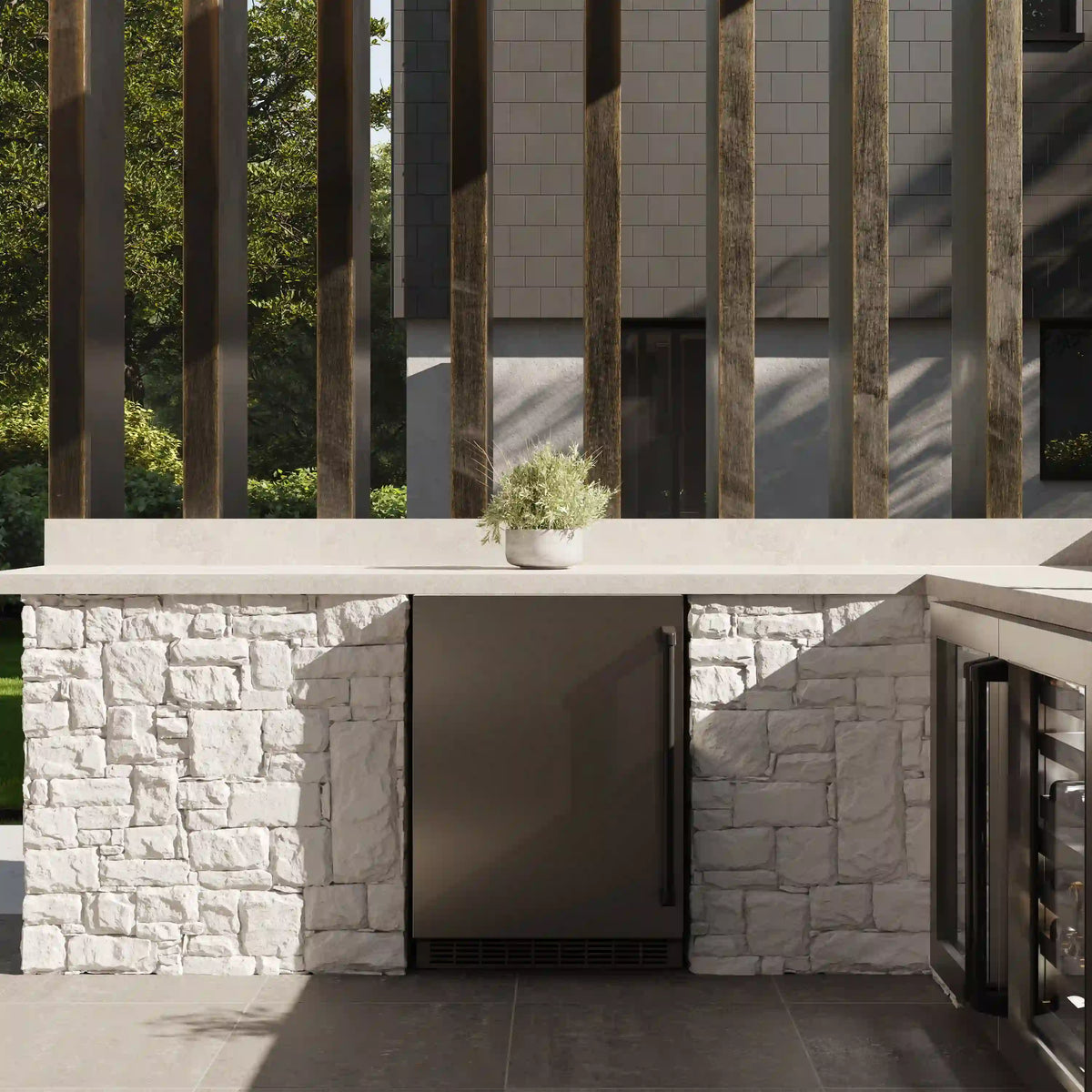 Built-in stainless beverage refrigerator installed under an outdoor countertop