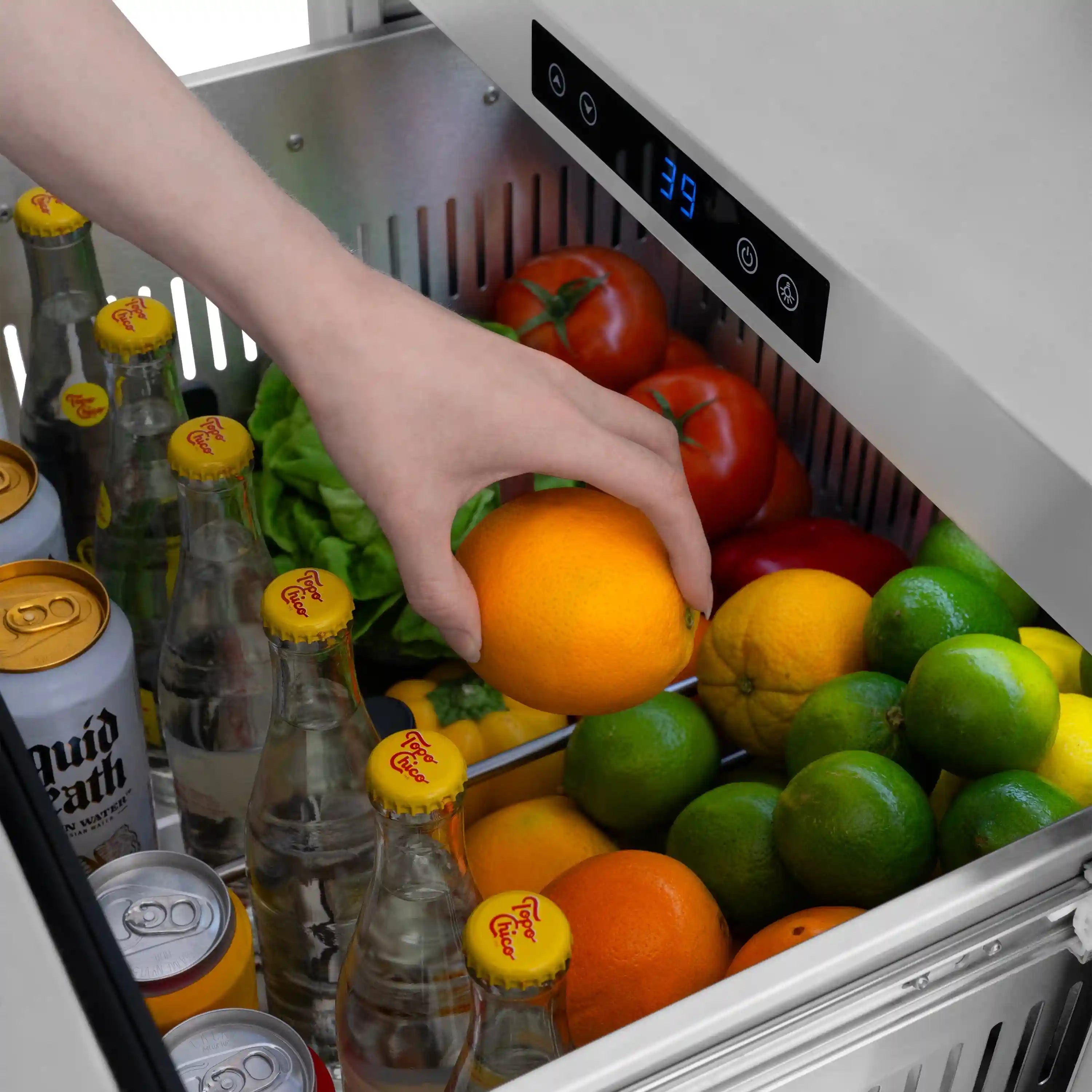 Refrigerator drawer filled with produce and bottled drinks