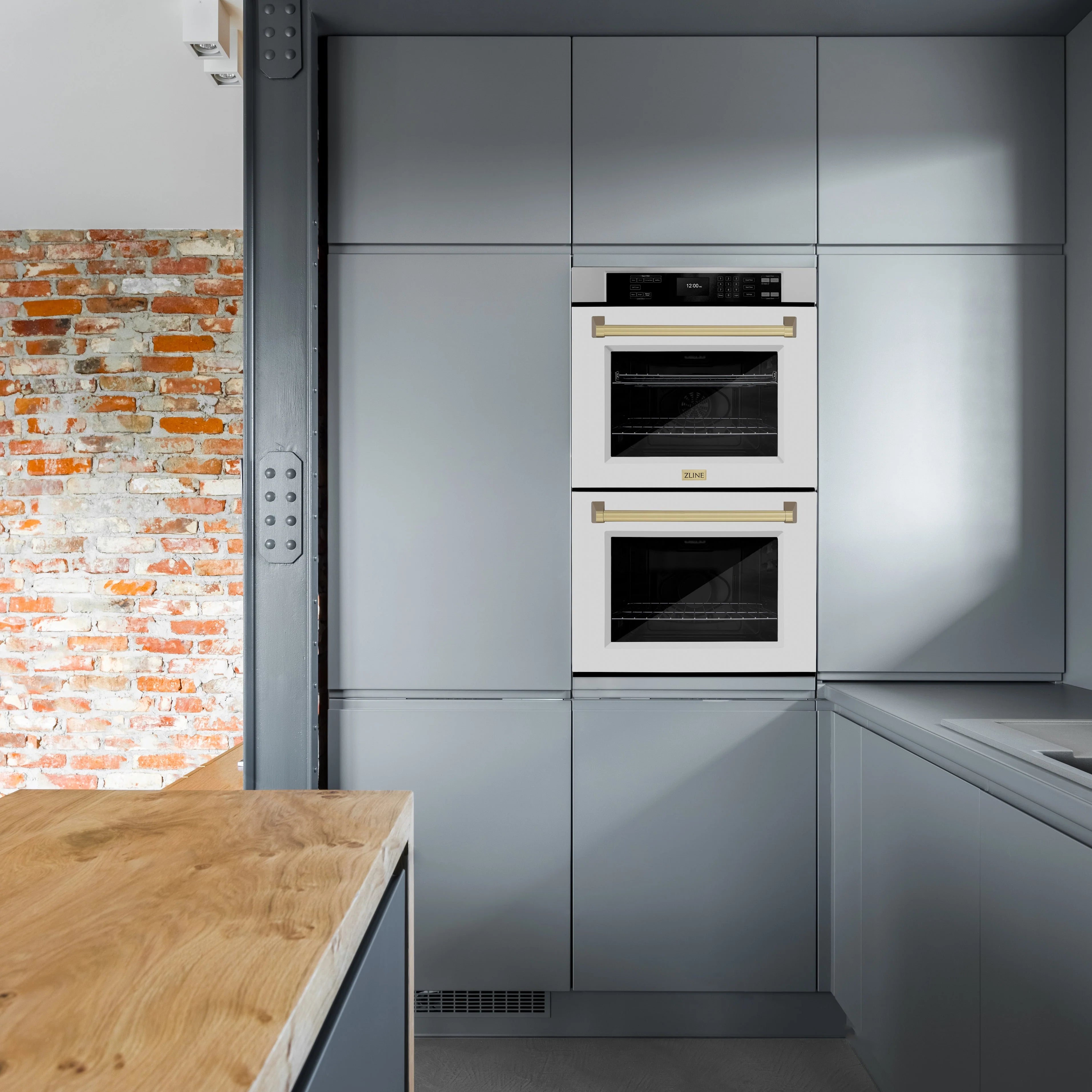 Built-in double wall oven with white matte doors, champagne bronze handles, installed in cabinetry