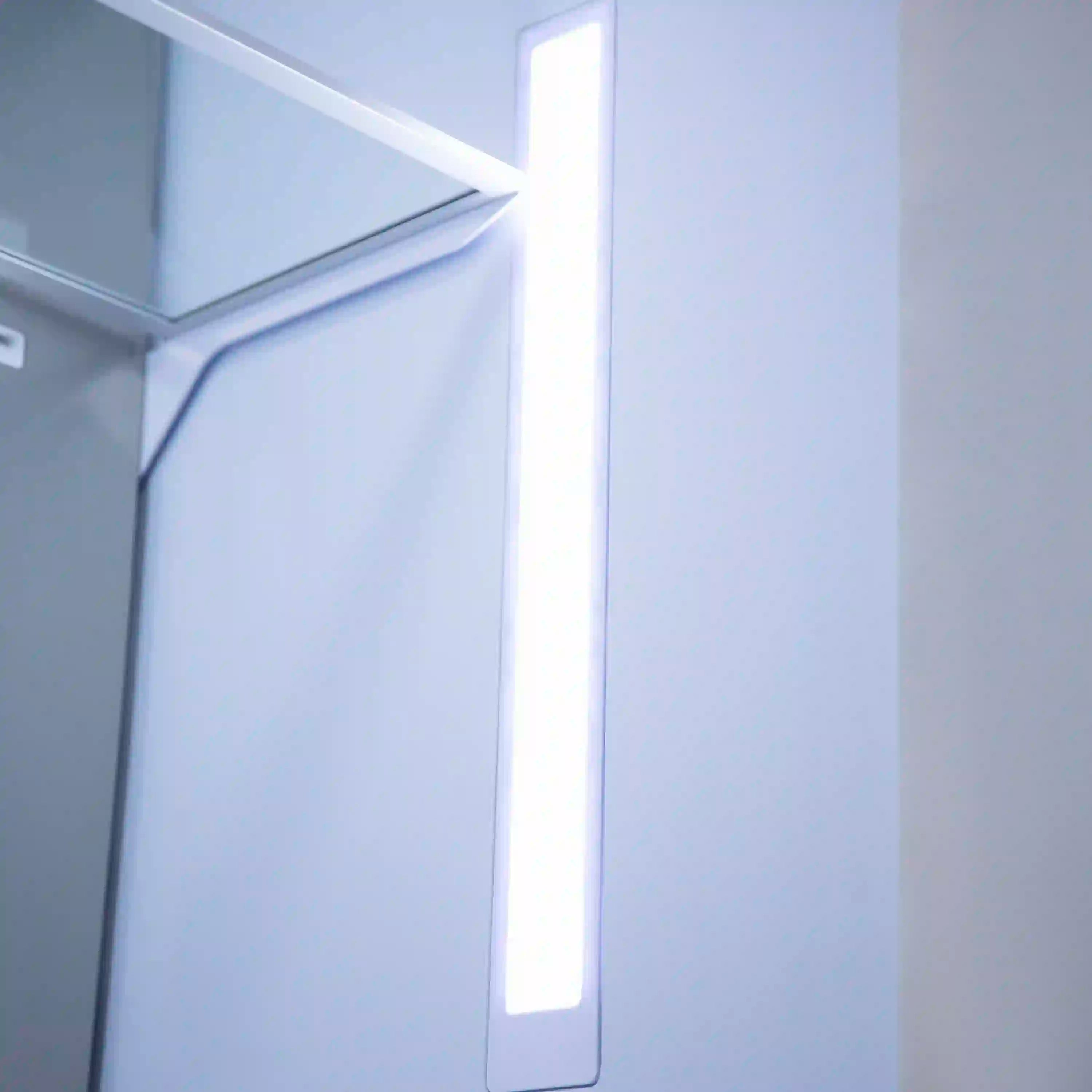 Open freezer door showing interior light and shelves