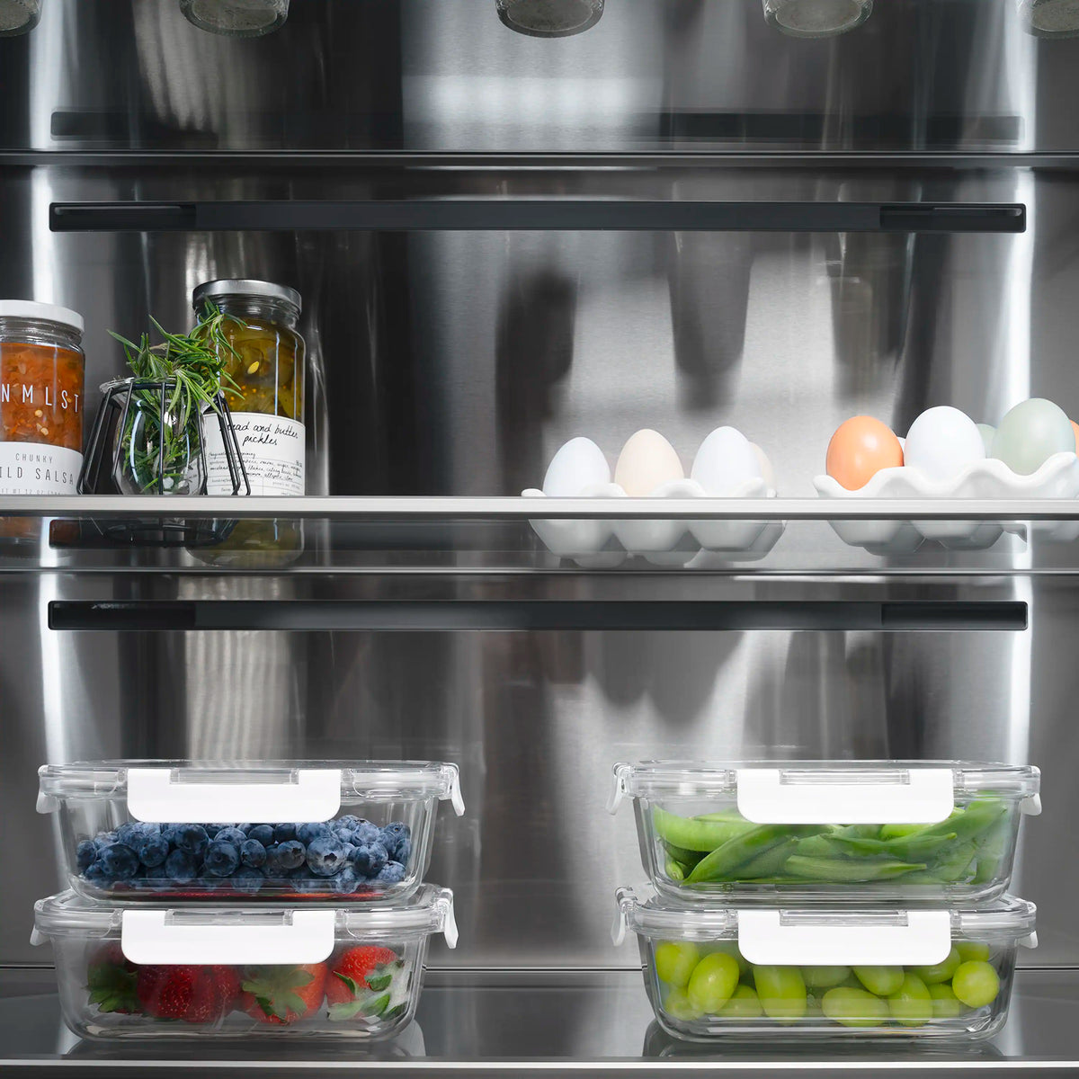 Refrigerator interior with shelves, egg tray, and clear door storage bins
