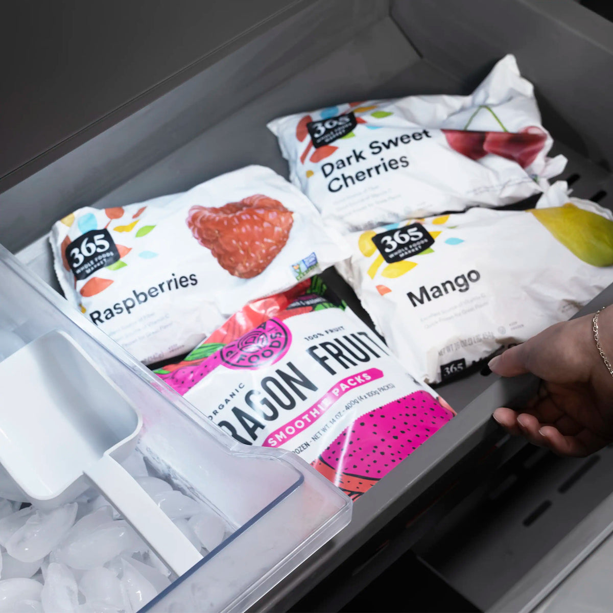 Top freezer drawer with packaged fruit snacks and ice bin contents